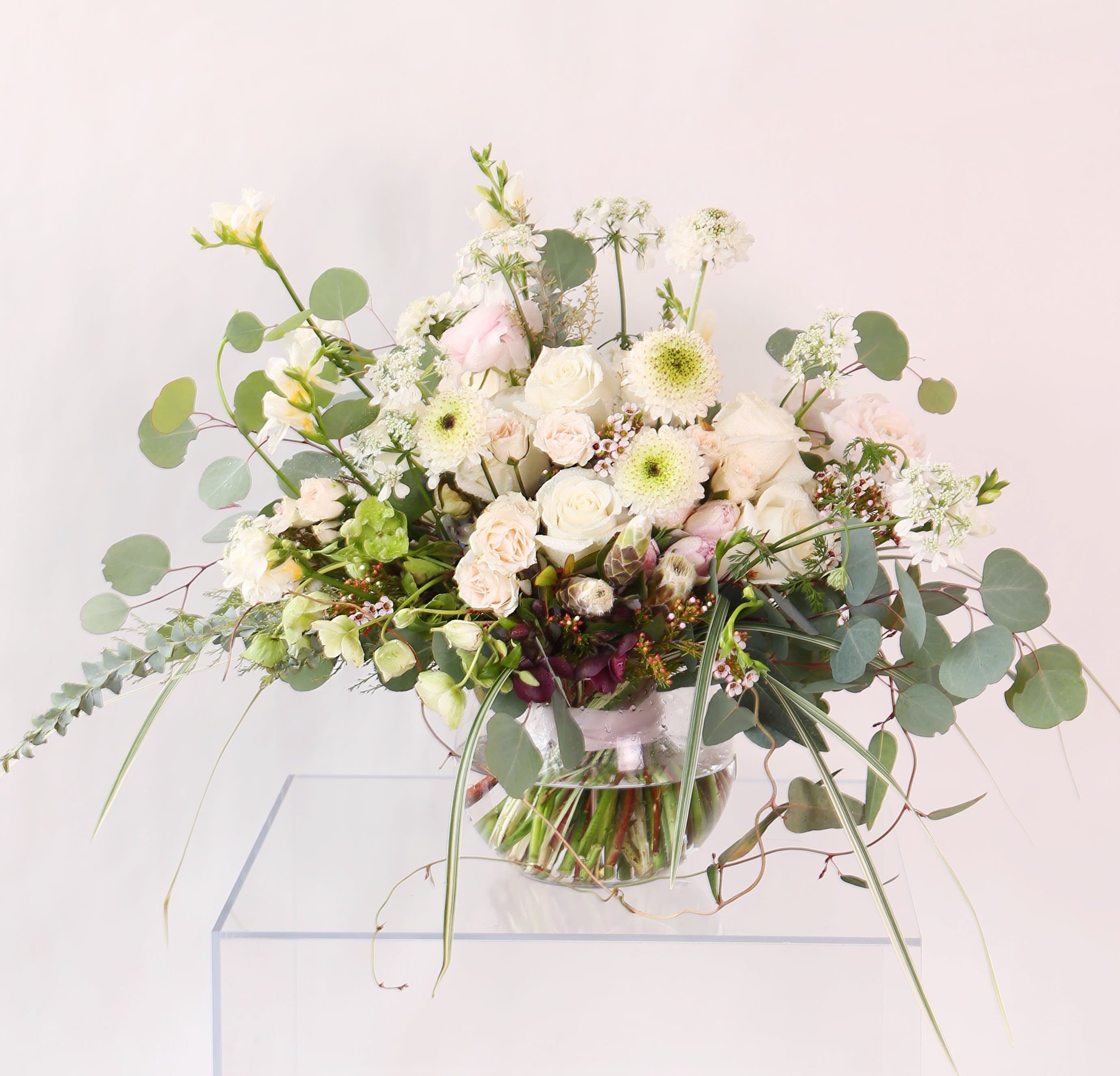 Ivory rose Garden  - Ivory /blush combo create an elegance , clean luxe rose garden look. It create by garden rose, Lisianthus, hydrangea, with seasonal bloom and green. Very gentle easy for decor anywhere. Its wrap with ribbon, Fits in 8" round vase. It will deliver with gift box and greeting cards.  Disclaimer: Photo just represent the overall style, look and feel, which may not be able to identically replicate in some instance. We will only substitute item of equal value or higher value. 