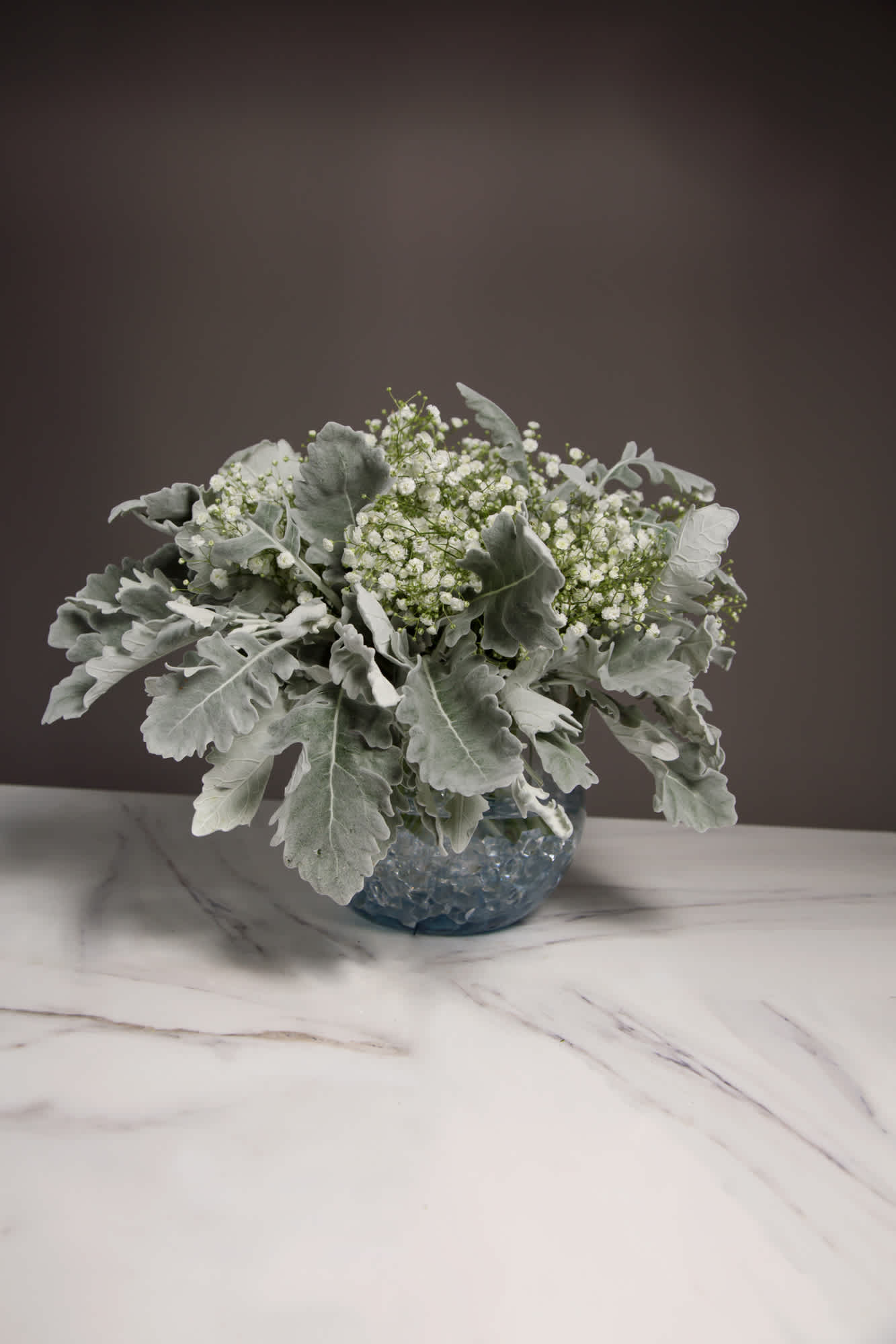 Deep Dusty - Deep Dusty is comprised of Dusty Miller and Baby’s Breath, and has an inviting softness to it. The felt like texture of the leaves and fragility of the baby’s breath surrounding them pulls you in and settles you down.  