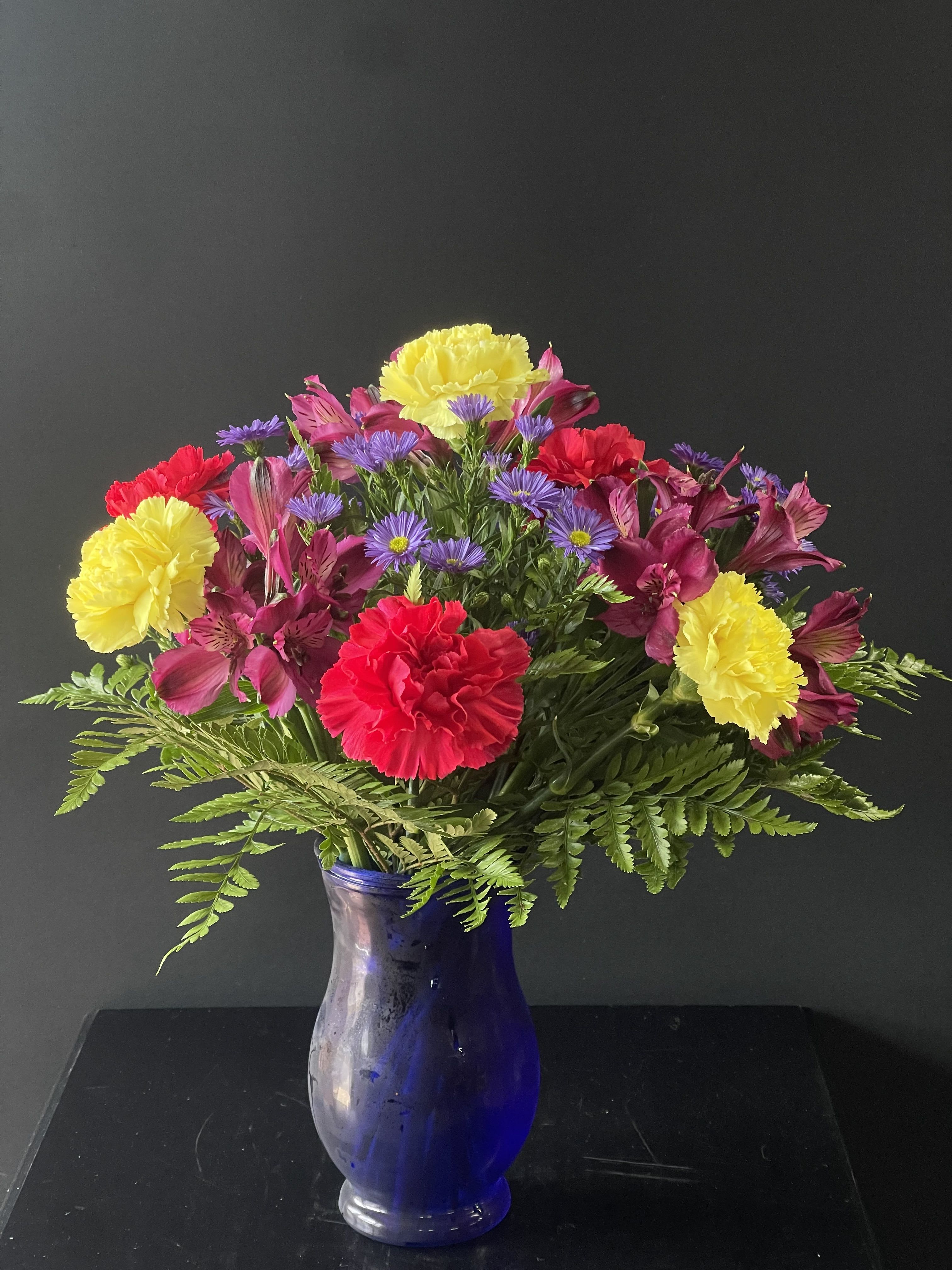 POPS Of Color  - A fun and bright arrangement with carnations, alstroemeria, and monte casino.