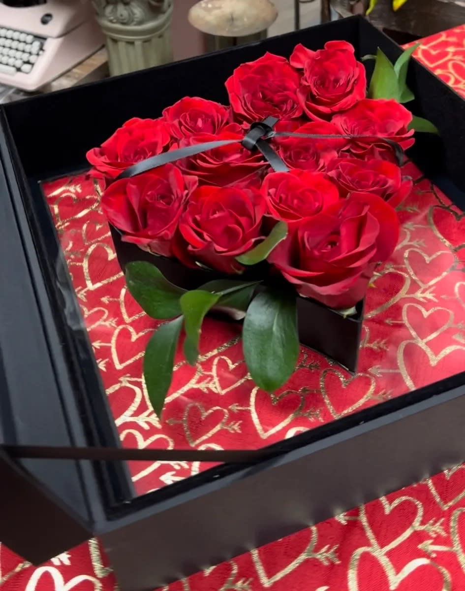 THE ULTIMATE KEEPSAKE LUXURY “LOVE” CARRY ON CASE - This ULTRA LUXURY LOVE “carry-on” is like nothing else available!  It something that will definitely blow your Valentines mind and heart!!!! This gift consist of 12 large bloom fresh cut Premium Red Roses set in A reinforced constructions, covered in silky fabric, features a suspended heart with hard liner, enclosed in a see-through hard acrylic keepsake box.Finished with a leather handle and metallic gold hardware, for a soft open operation. Box Measures 15.75” x 13.5” x 4.5”. Inner heart measures 9” in width. 