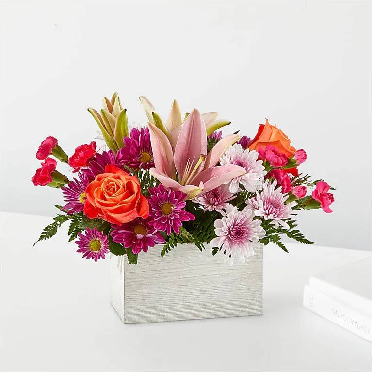 Light of My Life Box - From life's big moments to sweet just because sentiments, the Light of My Life Box Bouquet is designed to celebrate your loved ones any day of the year. RSVP'd to the party are hot pink carnations, orange roses, lavender cushion poms and lush greens.