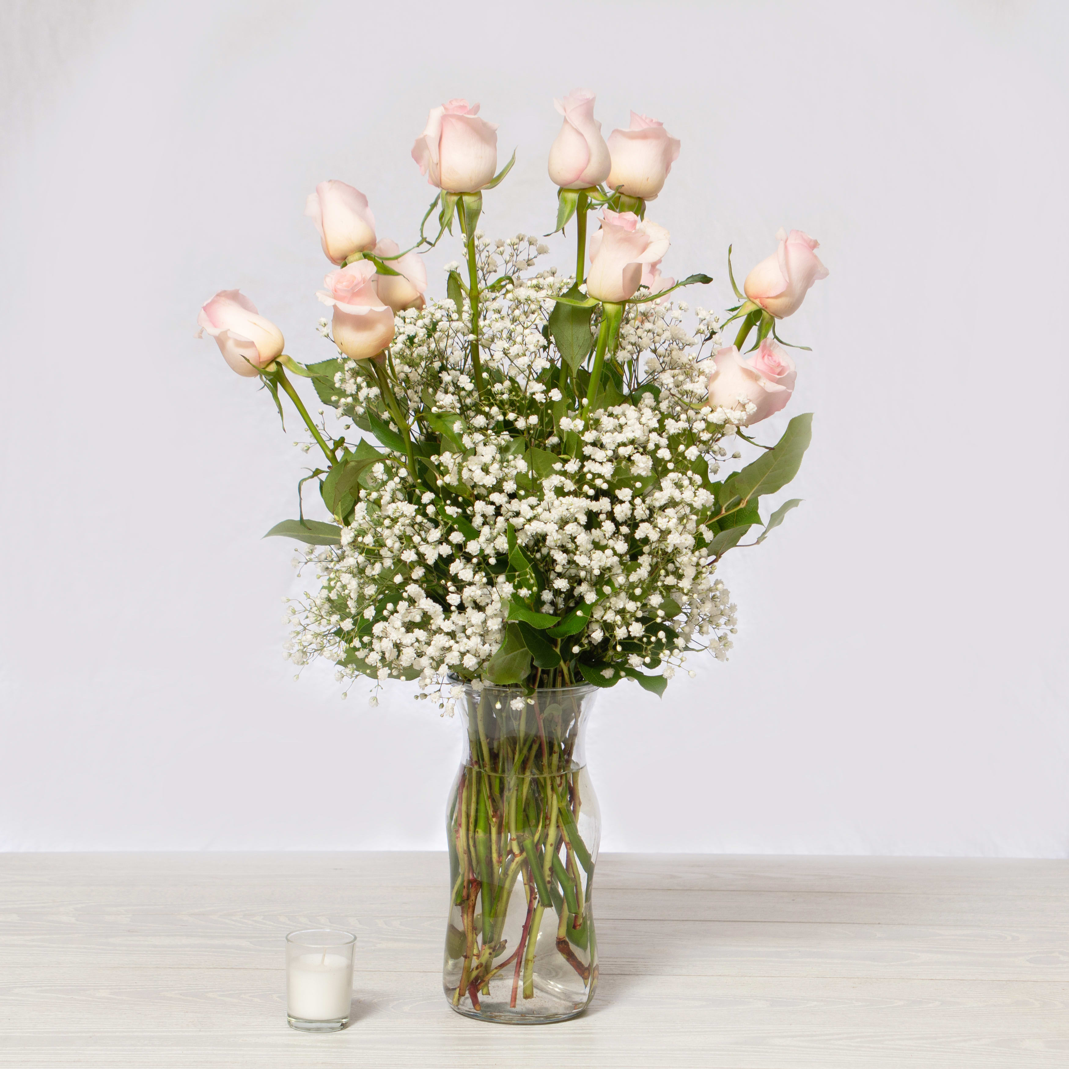 Dozen Pink Roses - Celebrate with a delivery of pink roses! Sweet and joyful, blushing pink roses are often associated with grace, innocence and happiness.  Please not the shade of pink may be different then the photo but it will be pink. If you would like 1 &amp; 1/2 dozen roses upgrade to deluxe, If you would like 2 dozen please upgrade to premium! 