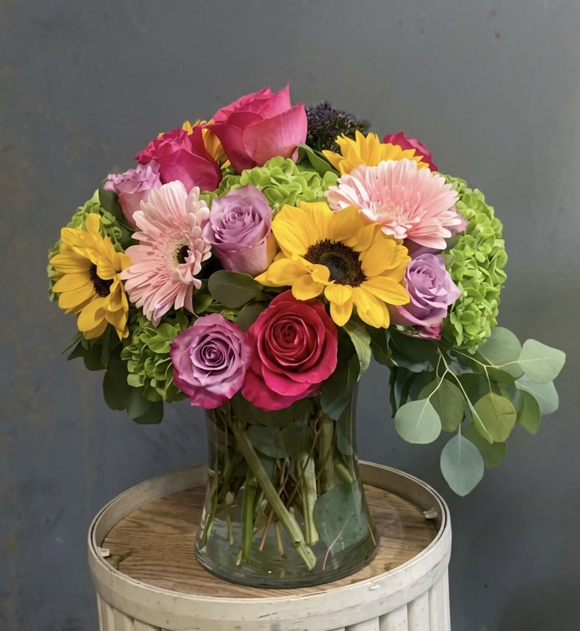 Spring Sensation - Our Spring Sensation arrangement is a beautiful array of hydrangea, roses, sunflowers and gerbera daises. A perfect gift for a new home or "just because"!