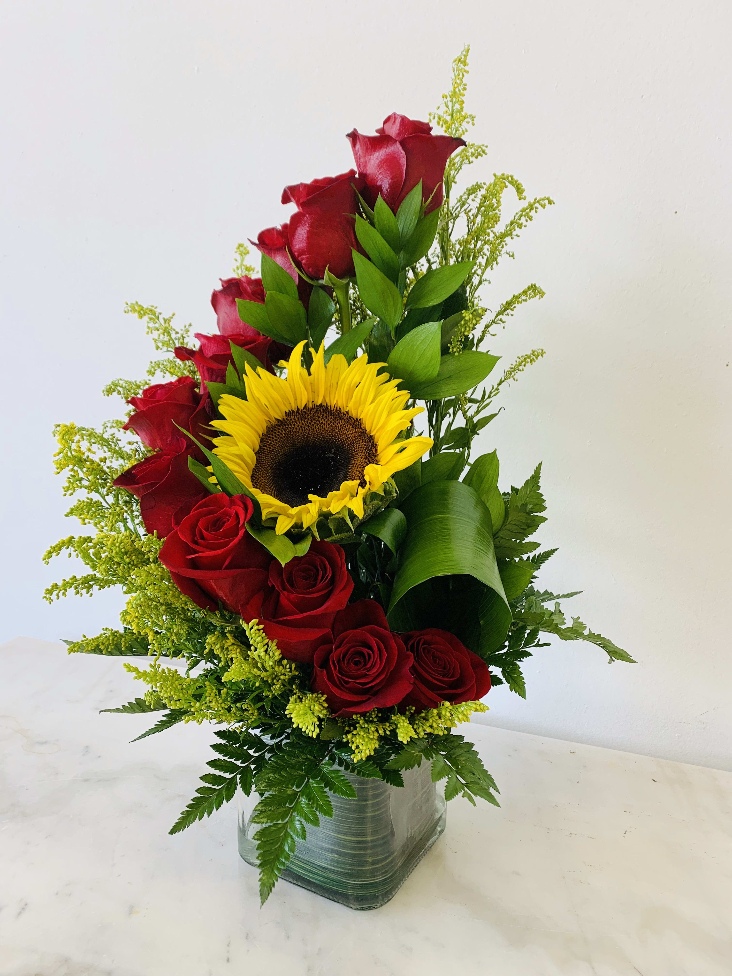 Red Sunshine  - Stairs red roses with a perfect sunflowers will make her day. You can use any color roses you want, please tell us in specific instructions if you wouls like to change it.   Standard: one dozen red roses Deluxe: two dozen red roses Premium: three dozen red roses  Pictures are for reference only.