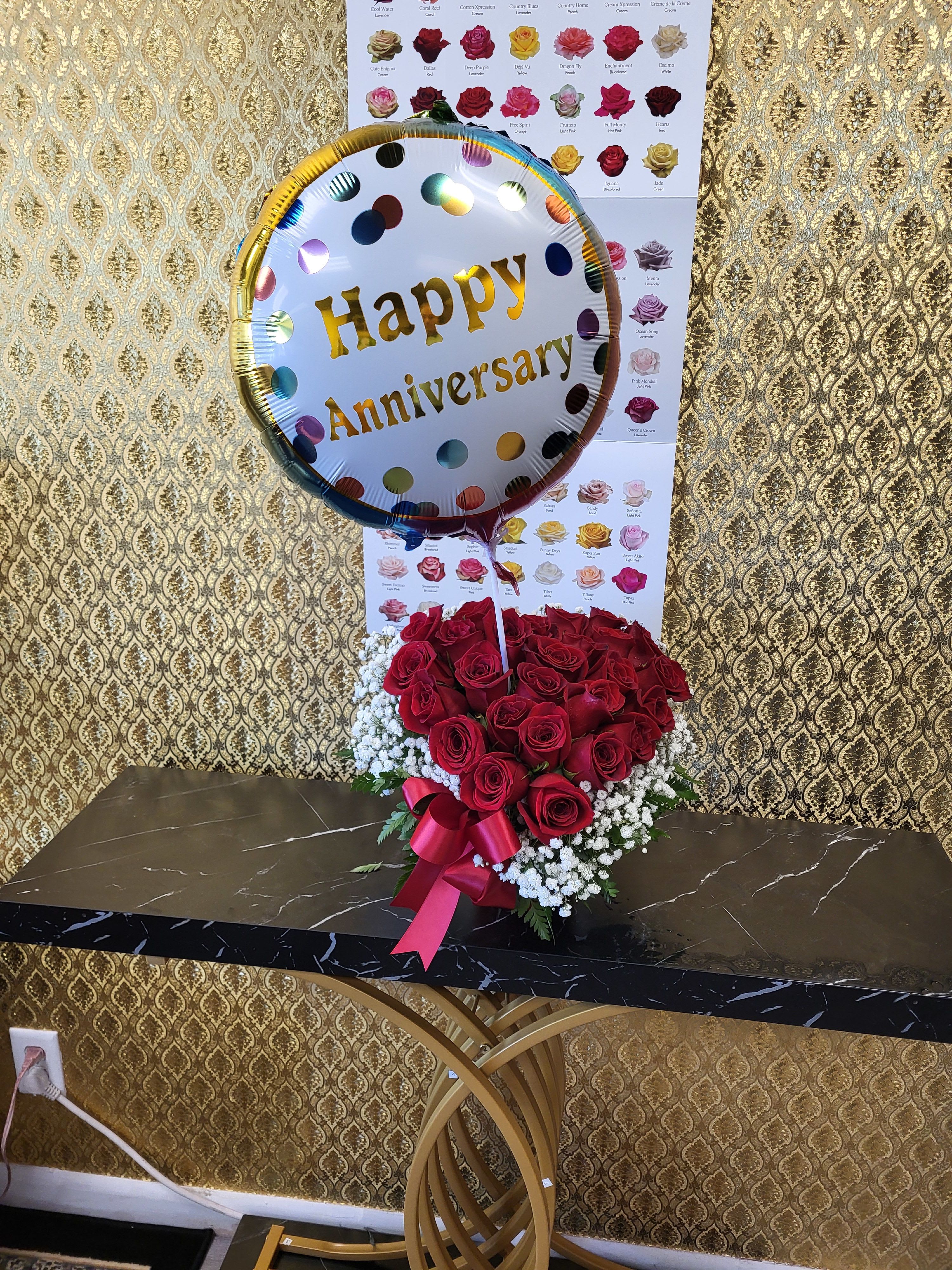 Happy anniversary WITH LOVE arrangement SPECIAL - Ellie Flowers exclusive, heart shaped designed in a round hat red box with grade AAA fresh cut roses, greeneries and baby breath.  Includes a clear vase, ribbon, happy anniversary ballon and message card with golden envelope. Please specify card message in your instructions.  standard: two dozen red roses deluxe: three dozen red roses premium: 4 dozen red roses