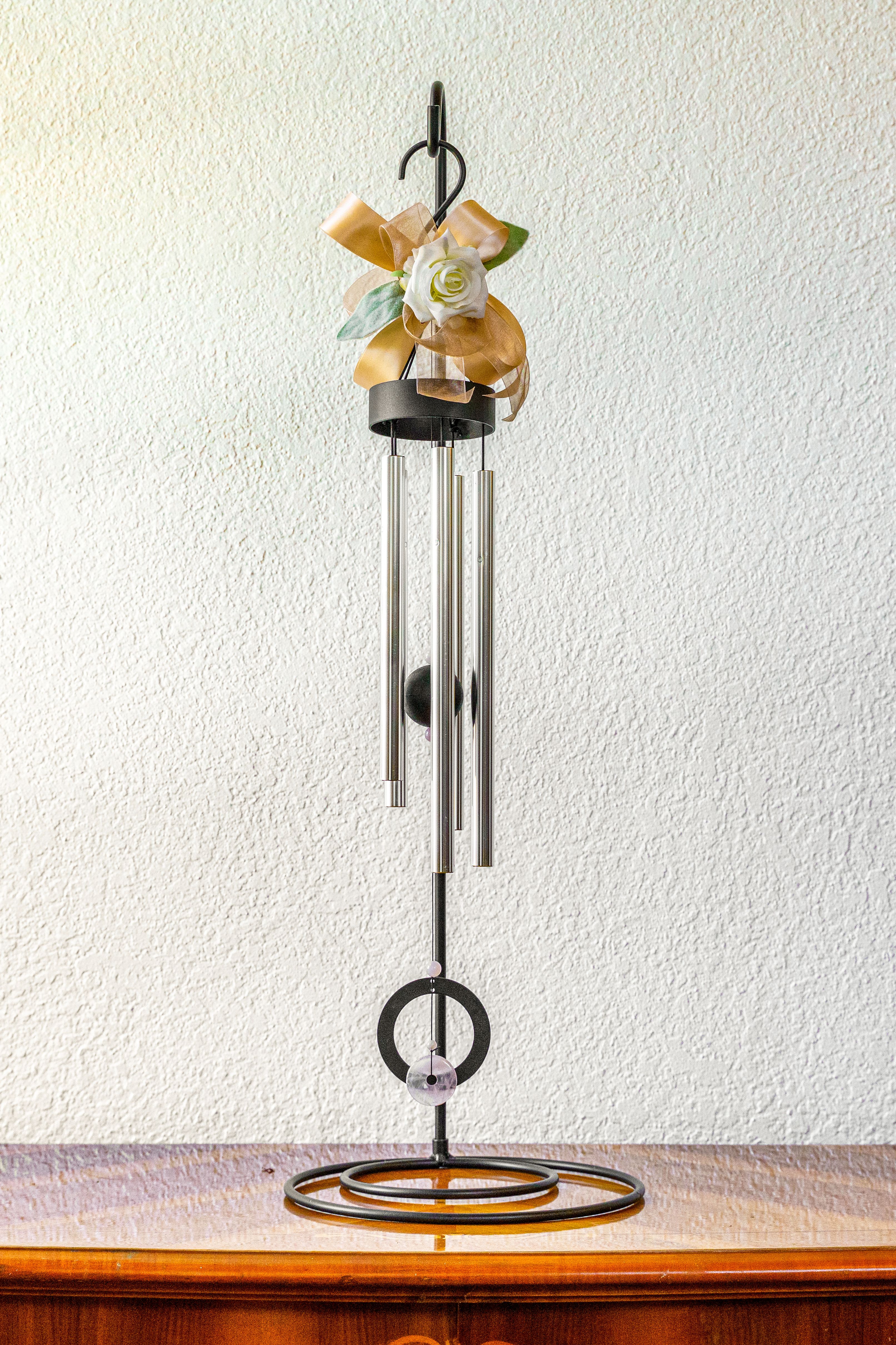 Memorial Windchime - Send a gift that soothes with each light breeze. Standing at 36", this chime will be a standout at any memorial.  Includes stand and ribbon color of choice, leave color preference in order notes. Default is a neutral white and green.  36" H X 6" W