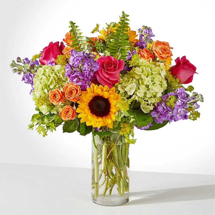Vibrant Greetings Bouquet - Feel the beauty and joy of the rainbow with this colorful gift. The Vibrant Greetings Bouquet lends itself to all of life's moments.  Details The Premium Bouquet is approximately 18"H x 18"W. Designed by florists, ready to display. For long–lasting blooms, replace the water daily. We suggest trimming the stems every couple days. Pet Safety Precautions: This bouquet or plant may include flowers and foliage that are known to be toxic to pets. To keep them safe, be sure to keep this arrangement out of your pet's reach.