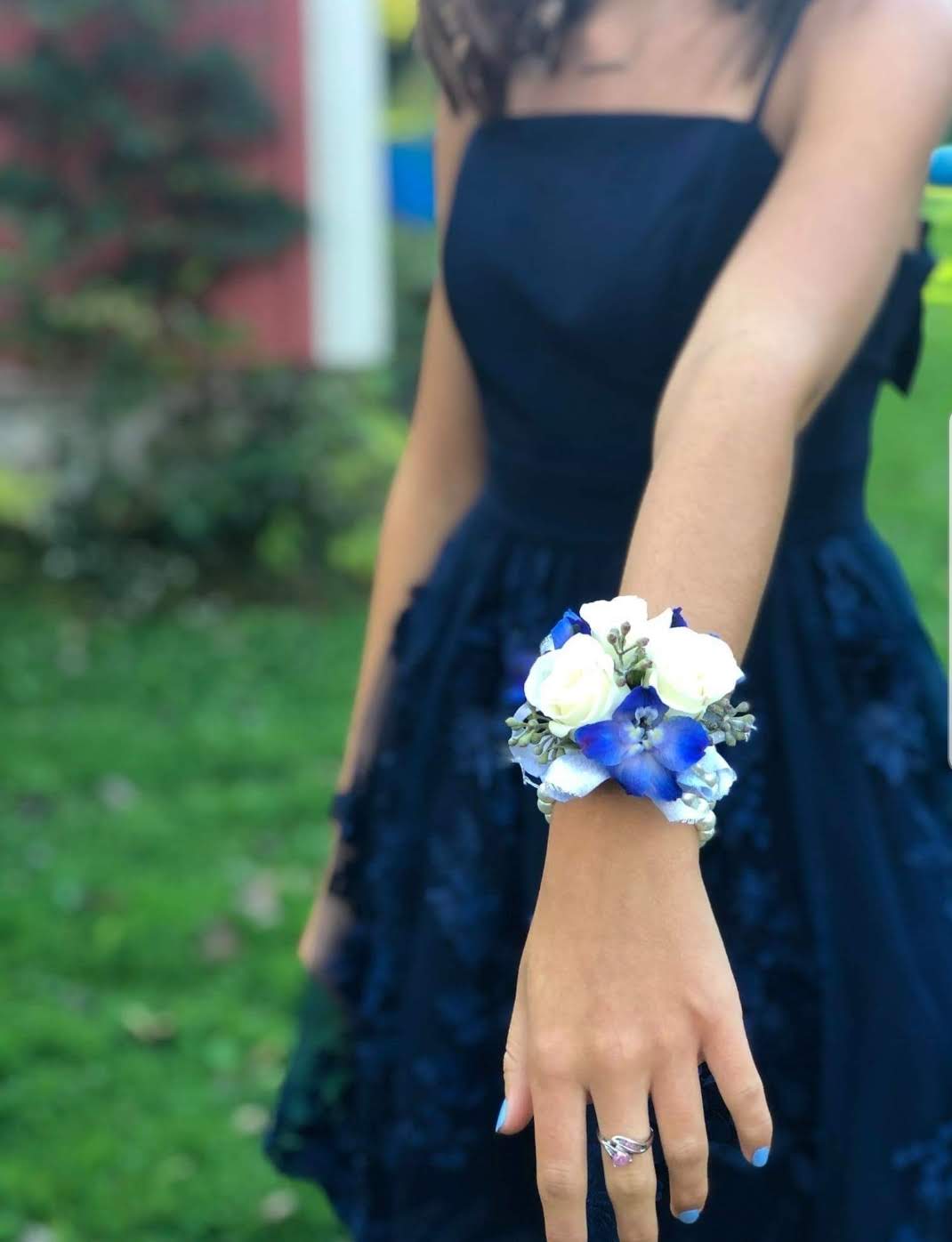 Shades of Blue wrist corsage - White roses and accented with blue delphinium