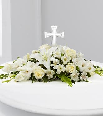 Eternal Light - The Eternal Light™ Bouquet is an exquisite arrangement that will bring a luminous beauty to life's most precious moments. An exquisite glass cross is surrounded by white roses, gladiolus, Peruvian Lilies, Oriental Lilies, vibrant Boston fern fronds and lush greens to create a wonderful arrangement ideally suited for a memorial service, baptism, First Communion, christening or wedding. GOOD bouquet, approximately 7"H x 28"W. BETTER bouquet, approximately 7"H x 29"W.