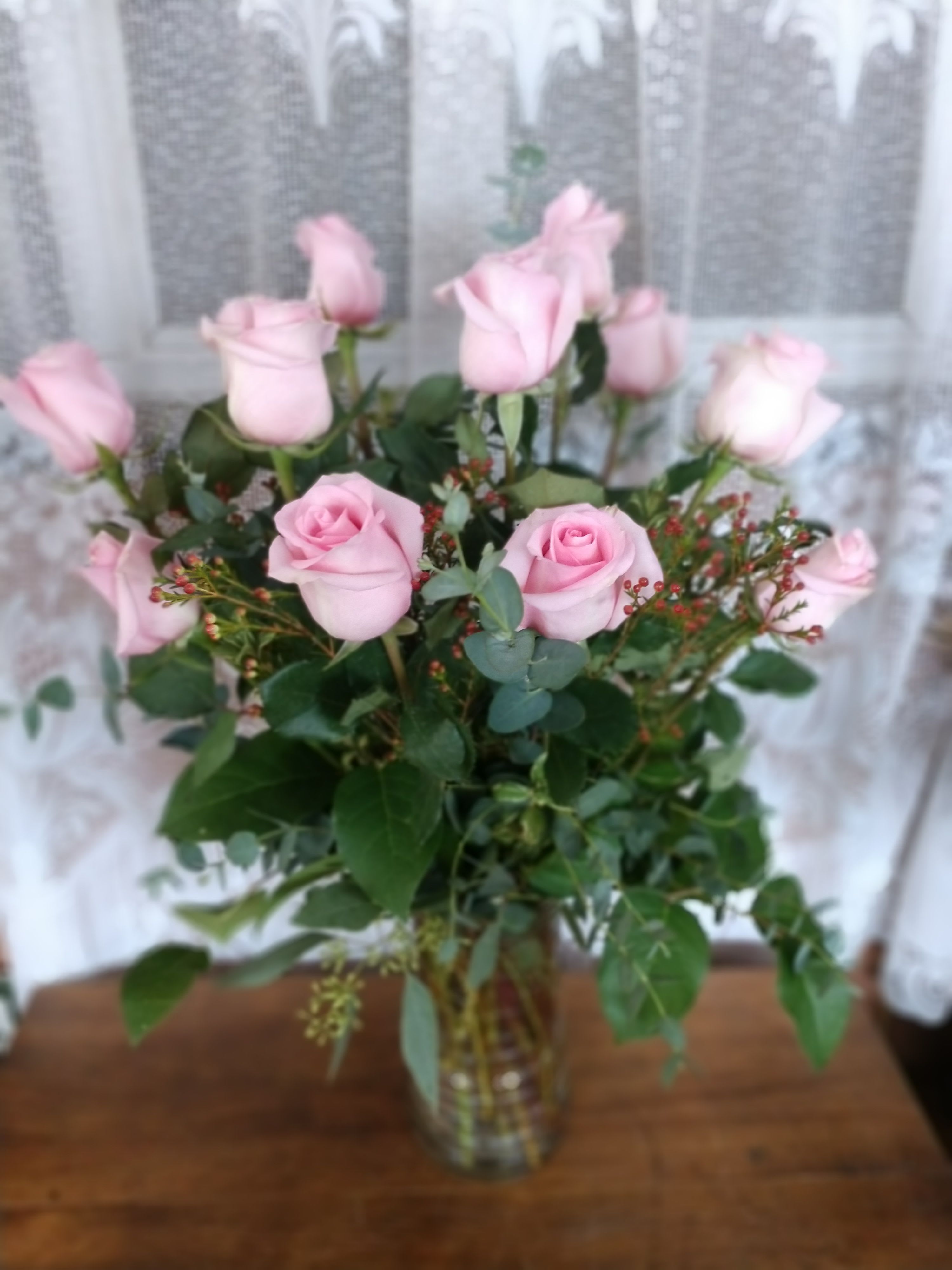 Pink Sweetness Premium - Say it sweeter with this feminine bouquet of pink roses and lush greens in a graceful glass vase.