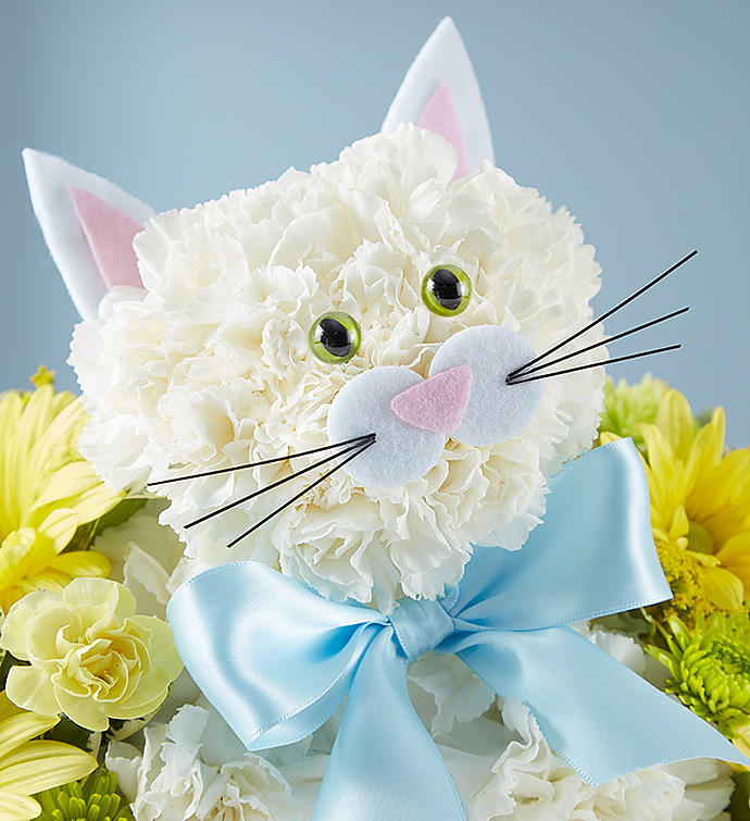 White cat-shaped floral arrangement with a blue bow and yellow flowers