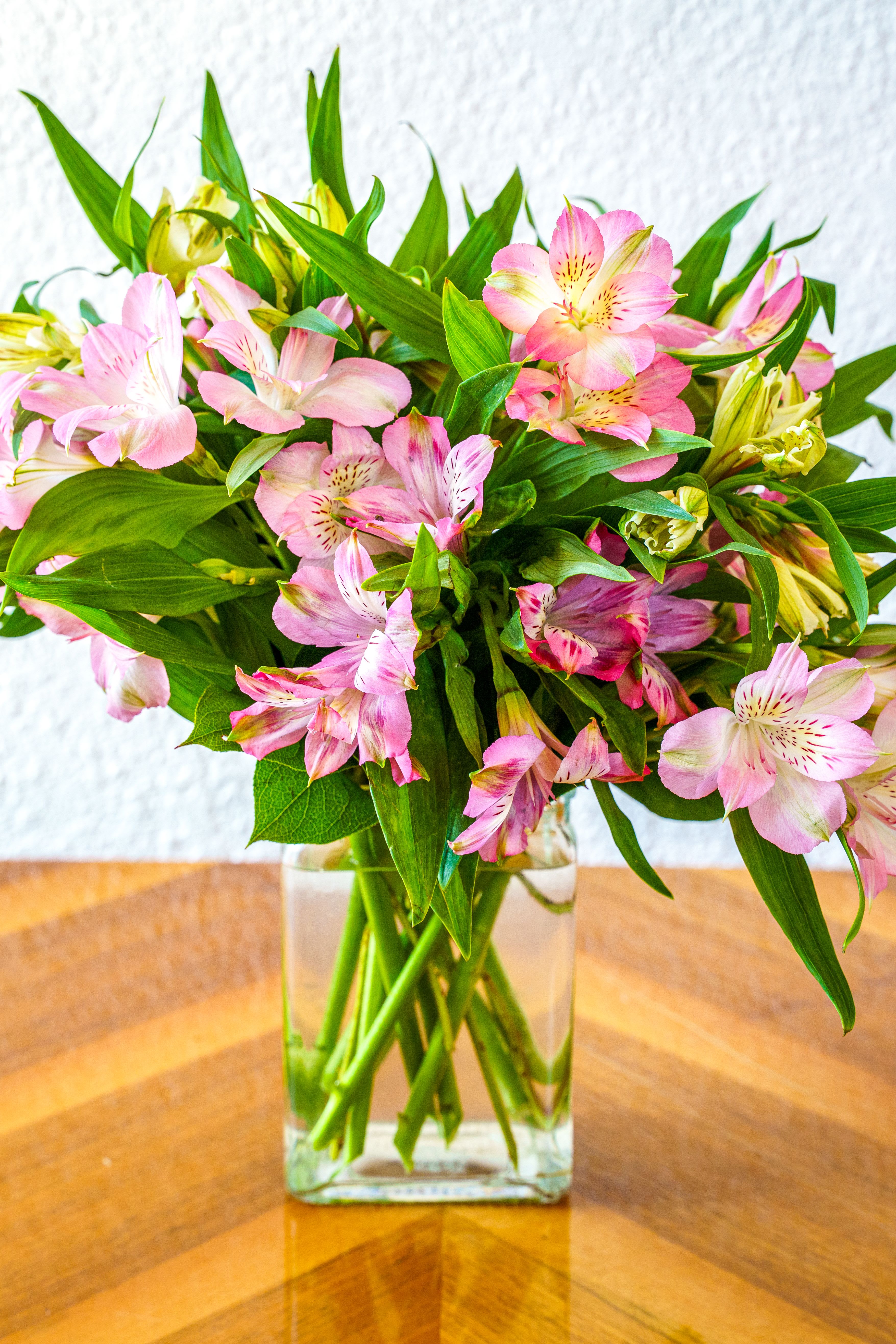 Just Tickled - A cheerful cluster of alstroemeria arranged upright in a clear glass cube makes this birthday bouquet or Mother's Day gift feel fresh and effortless. Just Tickled is designed as a general well-wishing flower arrangement that reads as bright, friendly, and sincere. The kind of gift that makes the person you're thinking of smile the moment they see it!