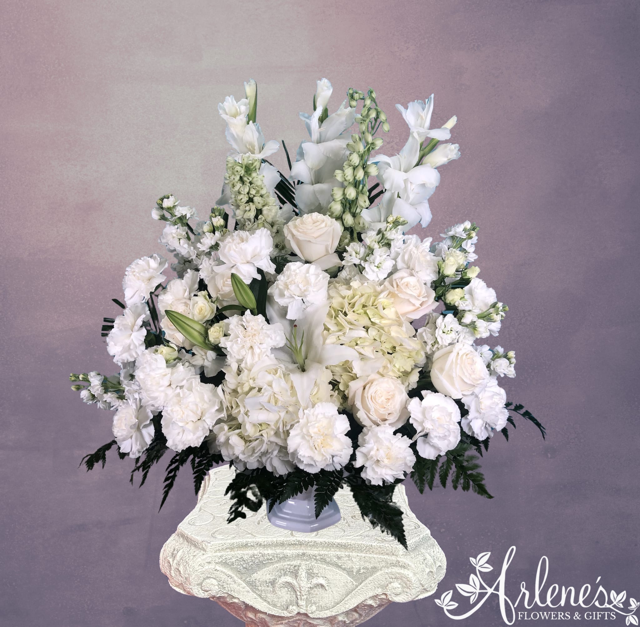 Soft as a Cloud Basket - What is more soft and soothing than a cloud? This floating vision of every white flower we could think of condensed in one arrangement. Fluffy hydrangea, gladiolus, sweet lily, carnations, roses and stock fill this white basin.