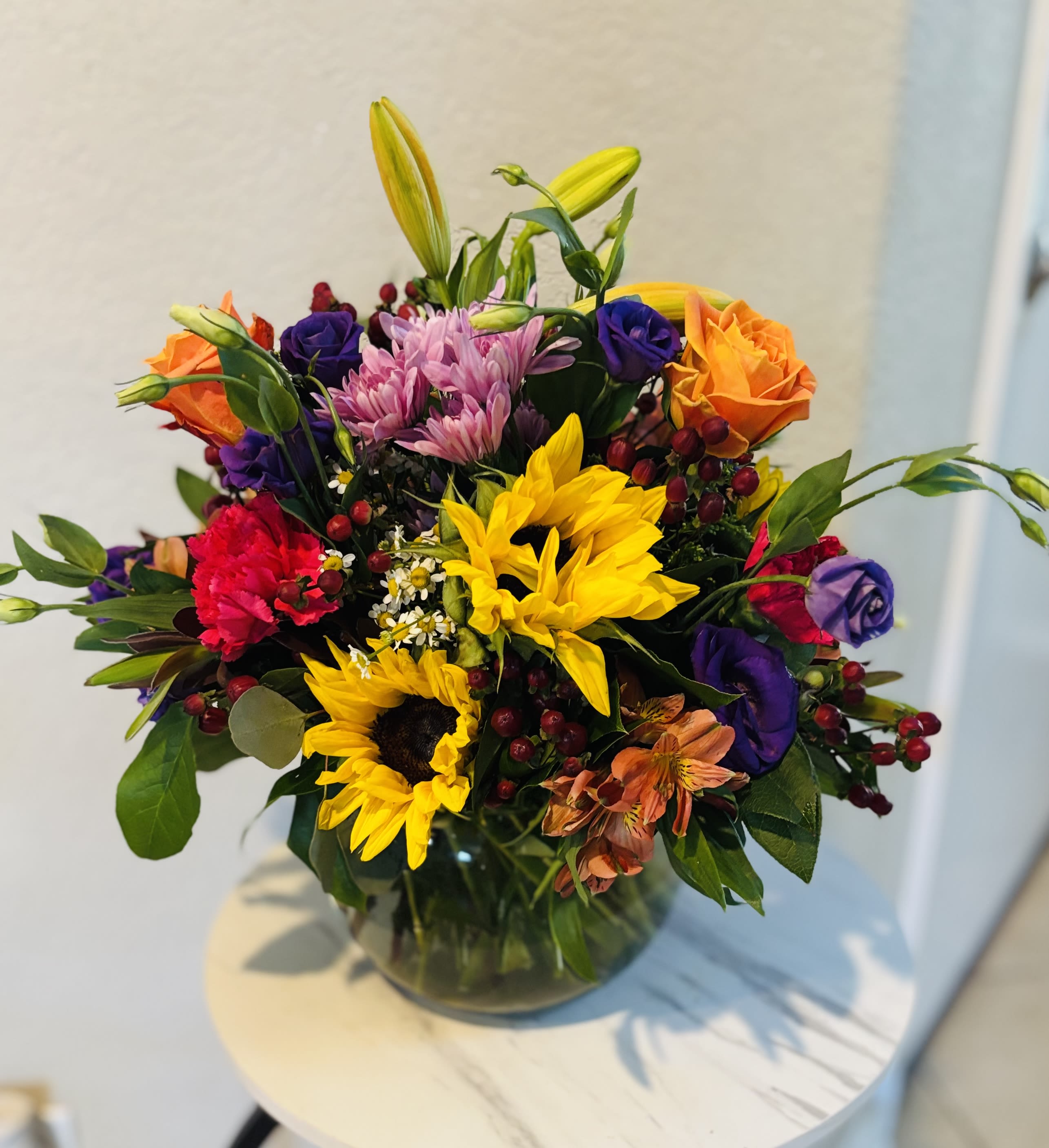 Sunflower Fiesta-Same Day delivery San Antonio - Bright sunflower and lily arrangement with roses, carnations and seasonal flowers, hand-designed by Snyder Flowers, a trusted local florist in San Antonio TX. Perfect for birthdays, get well wishes or to send a cheerful surprise. Same day flower delivery available in San Antonio.