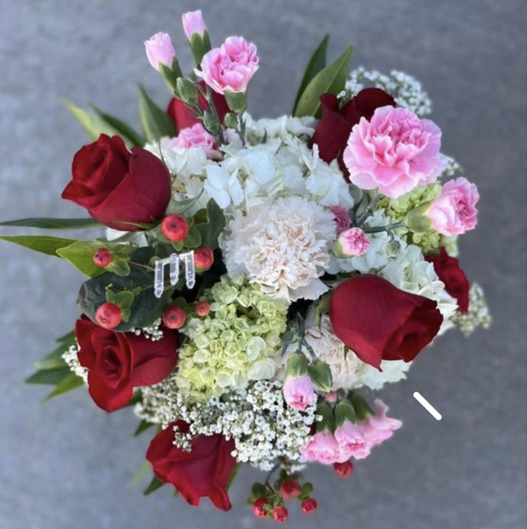 Every Girls Dream  - What more can a girl dream of than fluffy clouds of hydrangea sprinkled with red roses, delicate pink mini carnations and babies breath?  Our Every Girls Dream has them all!