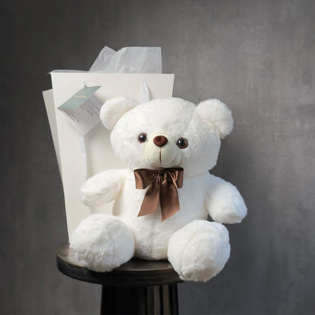 White Cuddle - A soft and adorable white teddy bear that makes any flower delivery even more special. Sweet, cozy, and perfect for romantic gifts, birthdays, or thoughtful surprises. Custom greeting card included.