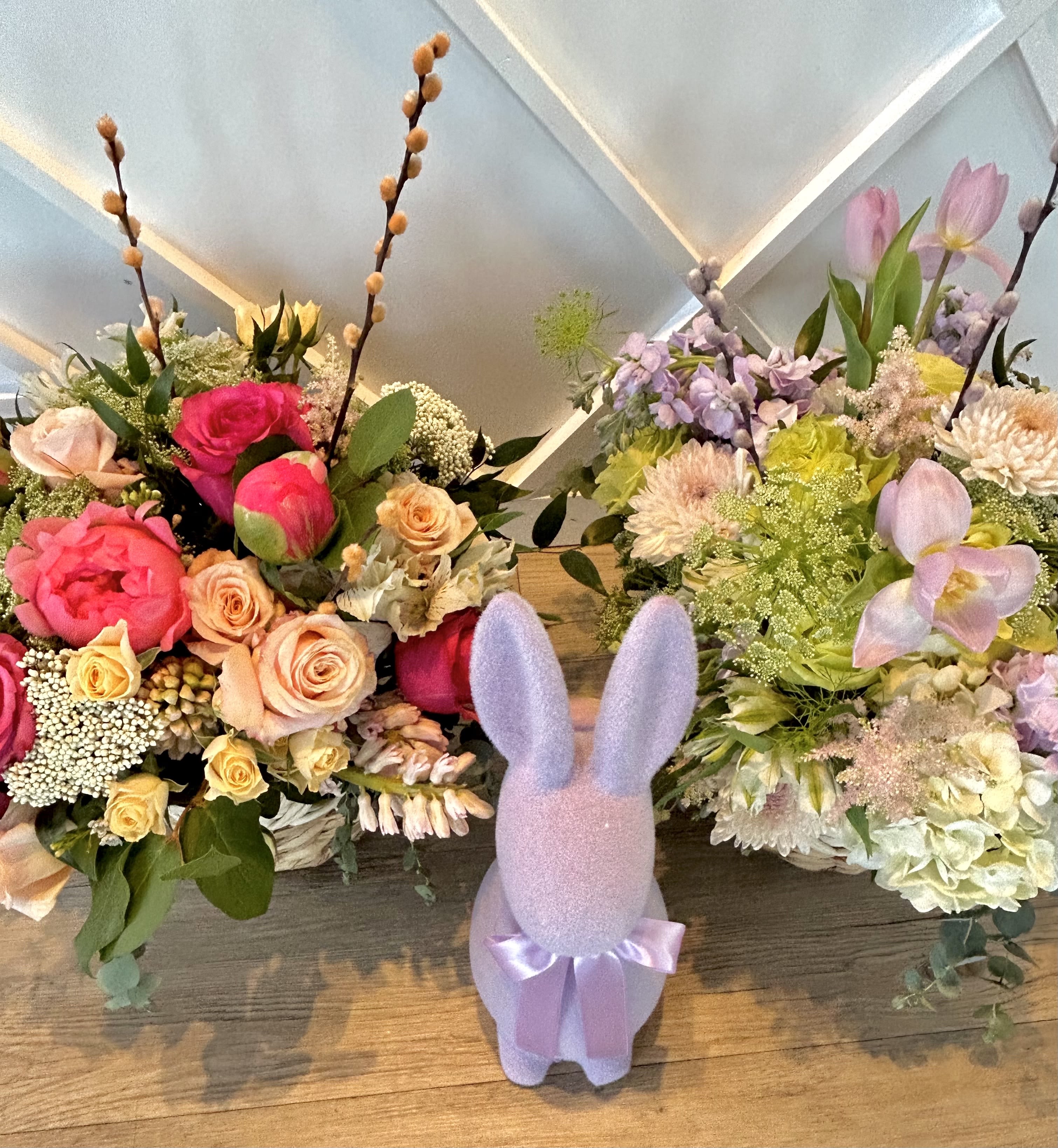 Basket O Blooms!  - Easter and Spring here we are!!!  This arrangement is so perfect for Easter and springtime celebrations and its blooming with a well curated palette!  Chose from the peachy palette or lavender.  Indicate in the notes.   The basket size is approx 8x8 and the flowers overflow!   Add on a beautiful chocolate egg or a 12 piece box of luxe chocolates from Westport's own Chocolatieree!  We wrap both together and they are simply spring stupendous!   STANDARD SIZE- 1x basket you pick the palette  DELUXE SIZE- 2X baskets open of each color palette Premium size- 1x basket and 1x chocolatieree chocolate egg.  You can sub in a 12 piece box of their gourmet chocolates if you like.   You can still add on the chocolate to any size order at checkout.  Sometimes we may have to sub in a flower- ie we may need to do lavender tulips for cream etc etc.  Bunny figurine not included ( Home Goods :))  