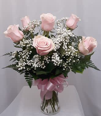 1/2 Dozen Pink Roses - 6 beautiful pink roses arranged in a vase with baby's breath and greens.