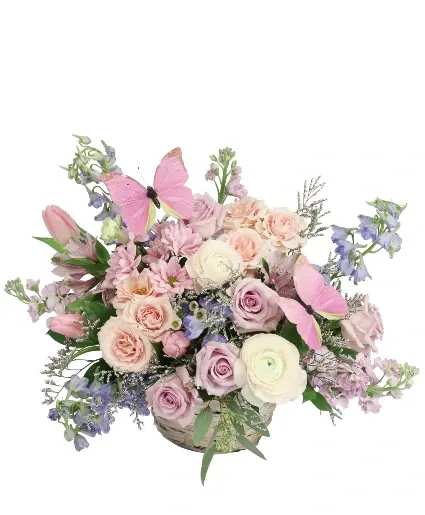 BLISSFUL BUTTERFLY BASKET ARRANGEMENT  - Make their heart flutter with this captivating arrangement! With pastel shades of purple and pink, Blissful Butterfly will have them floating in the clouds. Bursting with roses, tulips, delphinium, and more, this bouquet has it all. Send it to someone special today! 