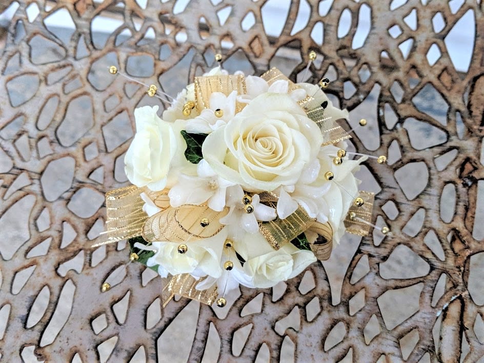 White with Gold Pearls Corsage - Shown as Standard White spray roses, hyacinth, gold pearls and gold ribbon come designed on a pearl wristlet. **In "special Instructions" you can tell us what ribbon color you would prefer to customize your order. *We custom design this arrangement and use the freshest flowers available the day of delivery. The arrangement in this picture is an example of the size and style and may not feature the exact product shown.*