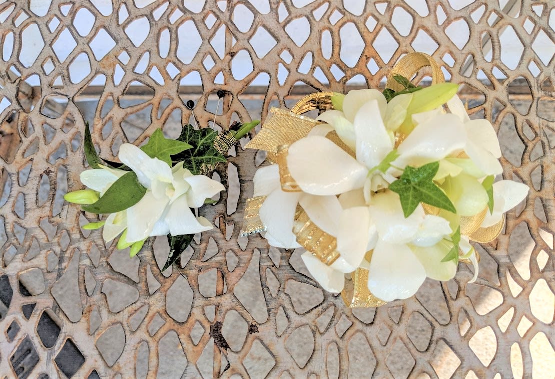 Gold &amp; White Dendrobium Combo - Shown as standard White dendrobium orchids and ivy come designed on a pearl wristlet with accenting gold ribbon. Boutonniere to match. *We custom design this arrangement and use the freshest flowers available the day of delivery. The arrangement in this picture is an example of the size and style and may not feature the exact product shown.*