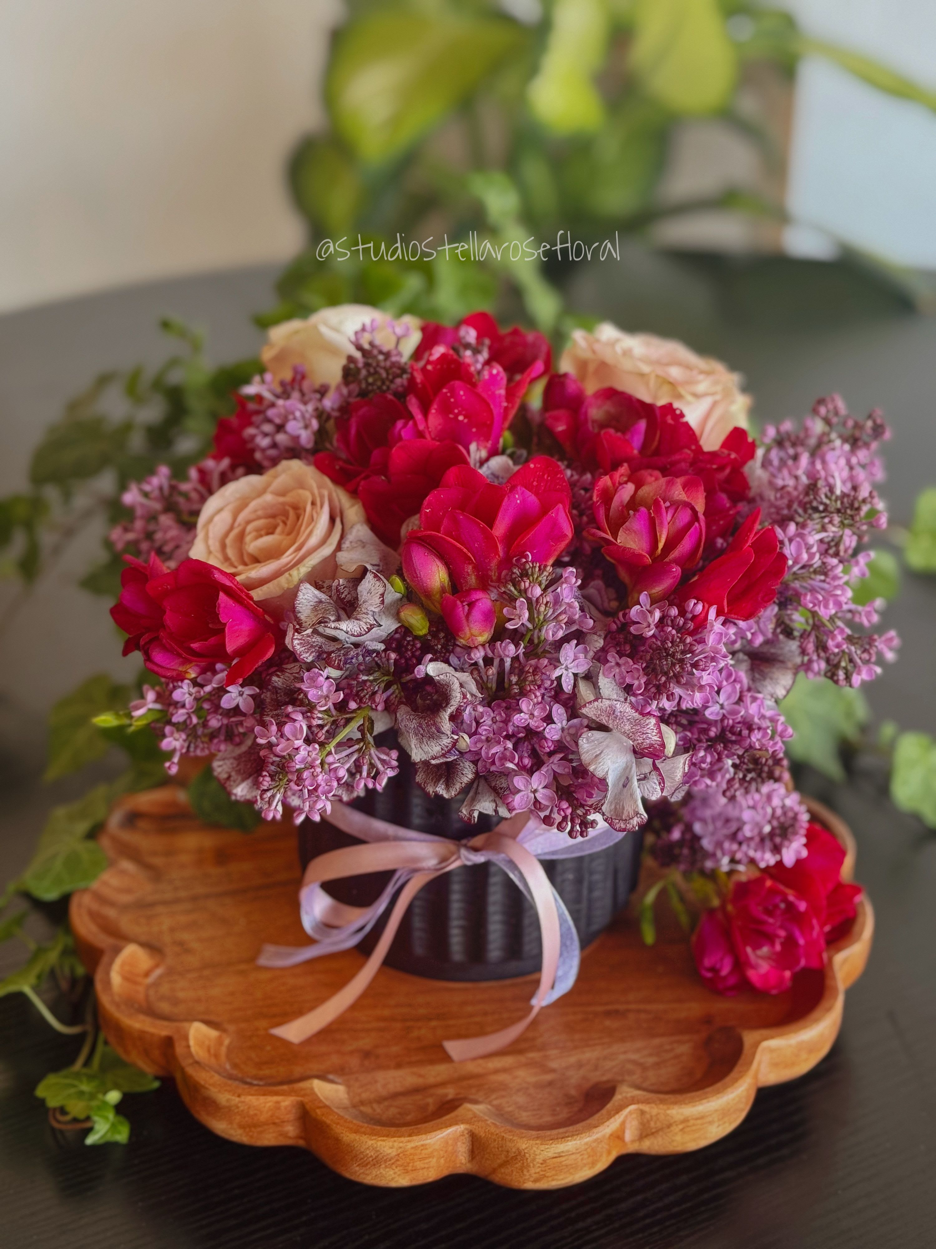 Lady Violet Bridgerton - Lady Violet Bridgerton is a graceful, romantic, and effortlessly refined design inspired by timeless elegance and the charm of a bygone era. This lush arrangement features fragrant lavender, delicate sweet pea, soft sandstone roses, and a whimsical touch of freesia. Each bloom is thoughtfully layered to create a garden stye composition full of texture, movement, and soft spring colors.  Perfect for an afternoon promenade, a meaningful Mother's Day gesture, or simply bringing a touch of classic beauty into the home.  **Please note: Vase styles may vary, while maintaining the overall aesthetic and quality of the design.**