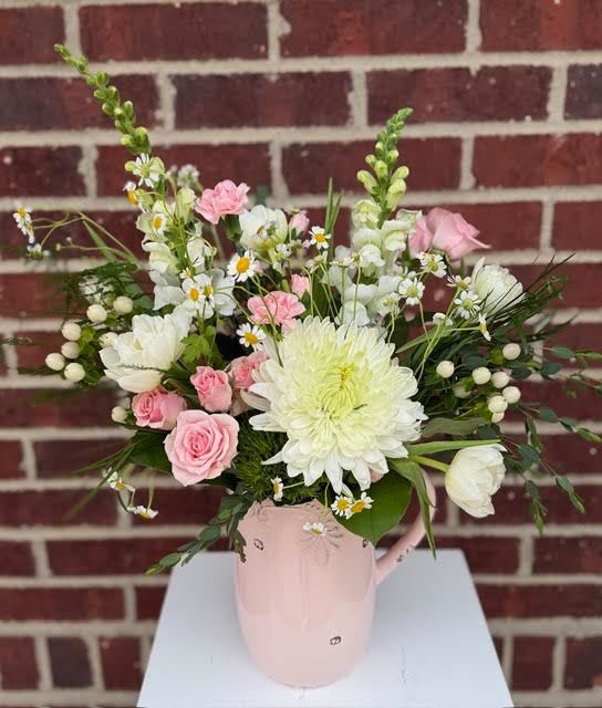 Pretty In Pink  - A lovely keepsake pink ceramic pitcher holds an array of coordinating blooms and unique foliage. Flower varieties will vary slightly based on inventory.