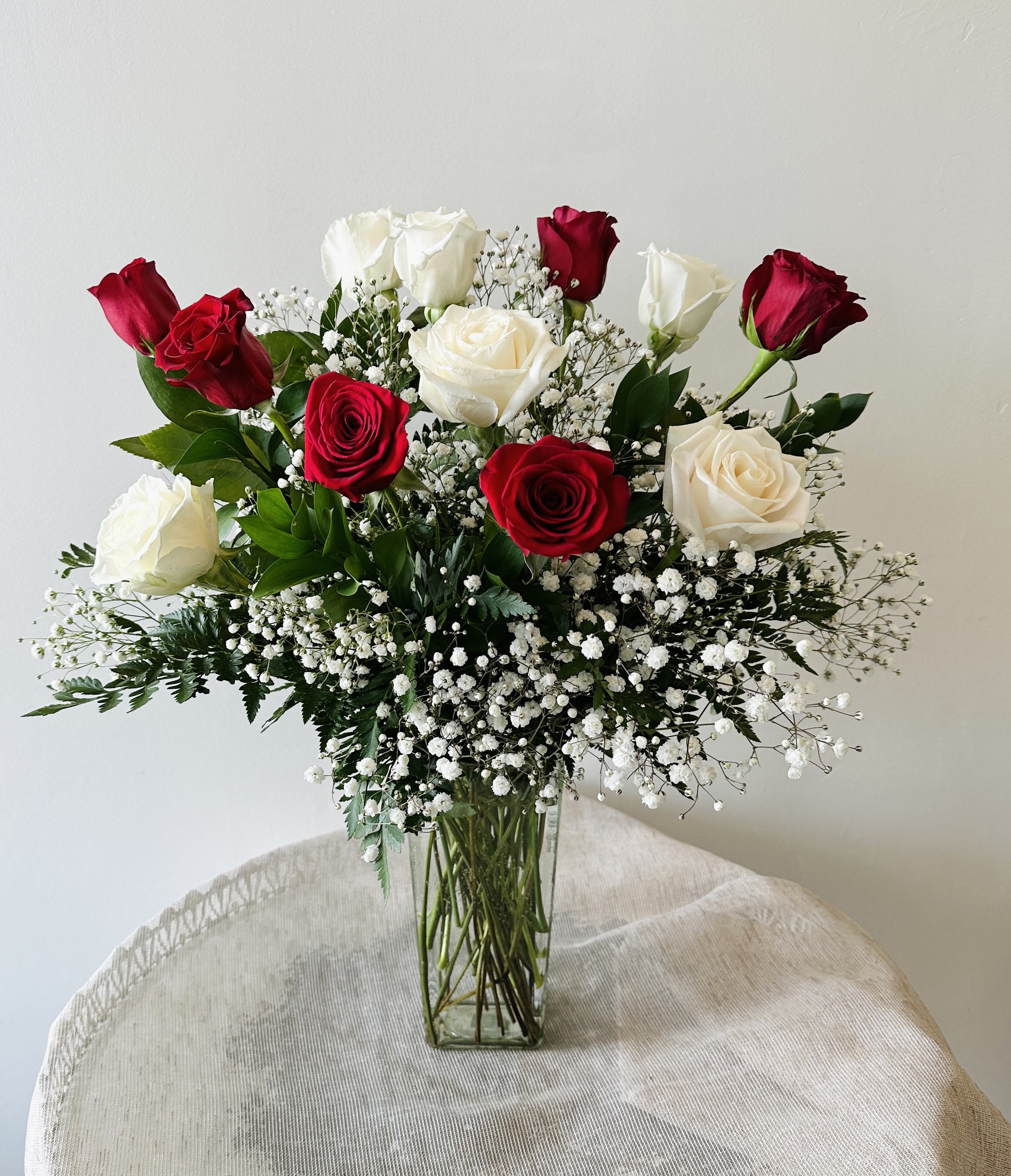 White and Red dozen in a vase -  Half white and roses in vase.  Standard: 12 roses Deluxe: 18 roses Premium: 24 roses