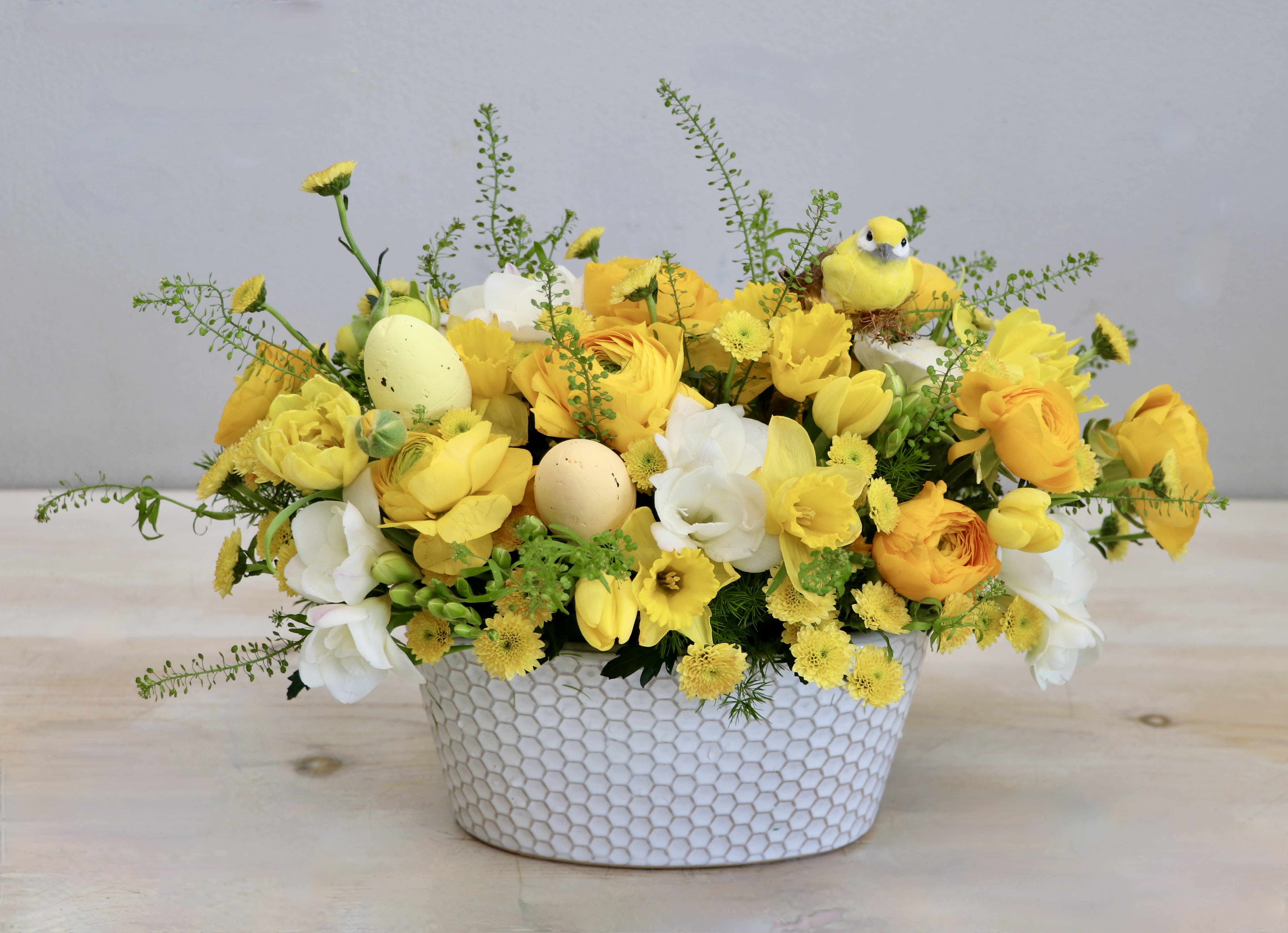 Egg-cellent Blooms - My WeHo - We love yellow! This themed arrangement is a mix of some of our favorite such as daffodils, freesia, tulips, and ranunculus all in yellows and whites. Get this in time for Easter before we run out! Photo shown is in the standard size, don't forget to upgrade for more blooms.