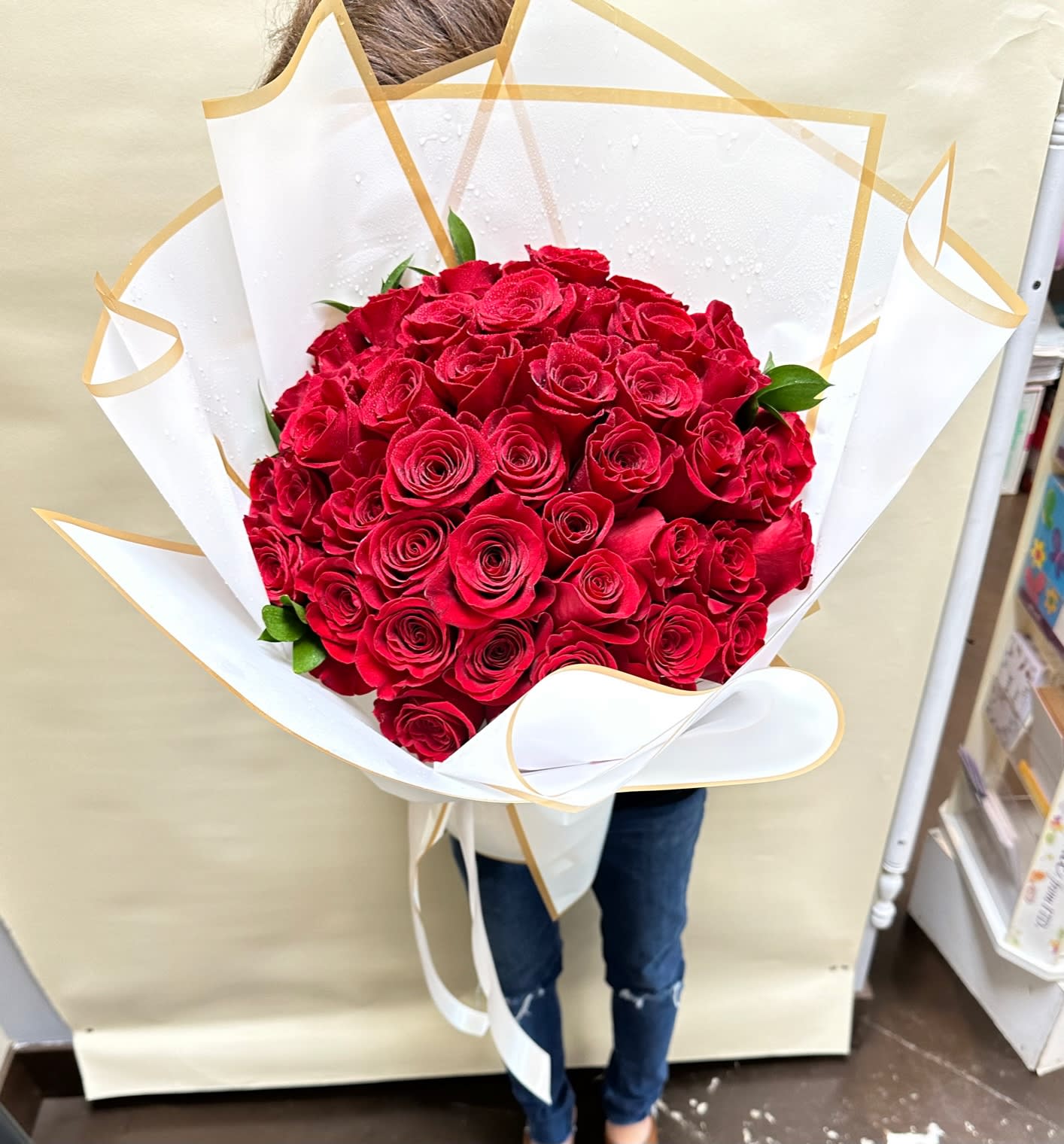 50 Red Roses Wrapped (Round Shape) - 50 Elegant Red roses wrapped in a round shape for any perfect occasion!  Standard: 50 Red roses Deluxe: 60 Red roses Premium: 70 Red roses  Note: Wrapping Color will be picked by florist if not specified in special instructions.