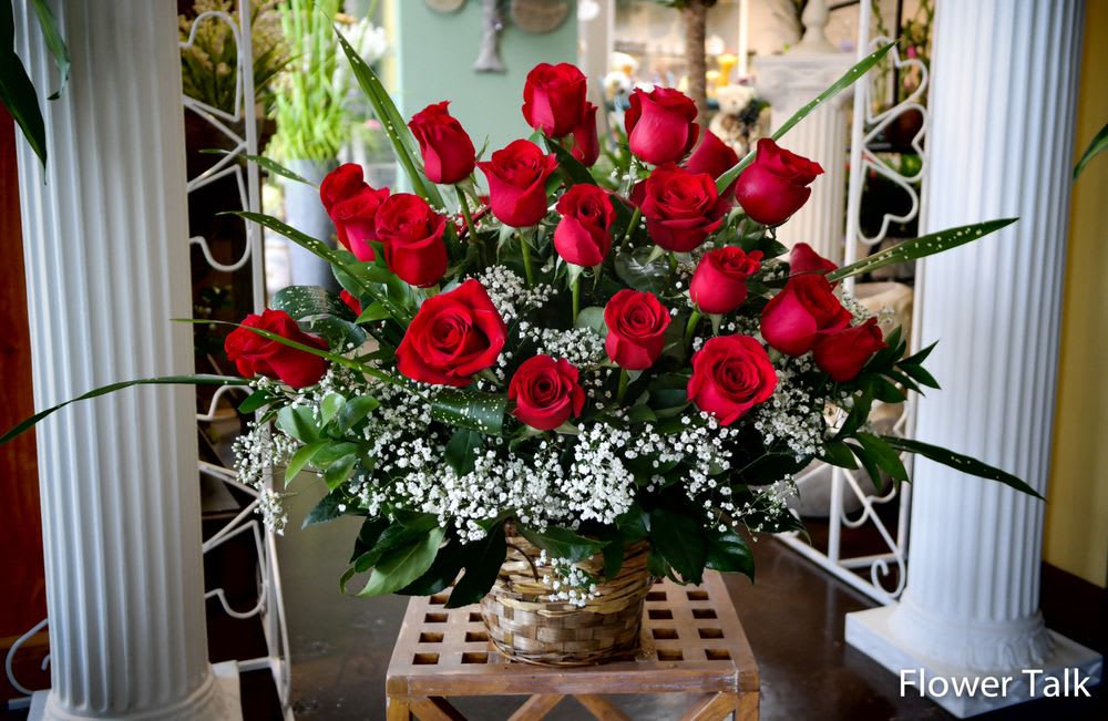 Flower Talk's Beautiful Roses Basket - Bright red roses with baby's breath flowers and greenery arranged in a basket.    Standard size: Approx. 2 dozen red roses with greenery and baby's breath in basket.  Deluxe size: Approx. 3 dozen red roses with greenery and baby's breath in basket.  Premium size: Approx. 4 dozen red roses with greenery and baby's breath in basket.