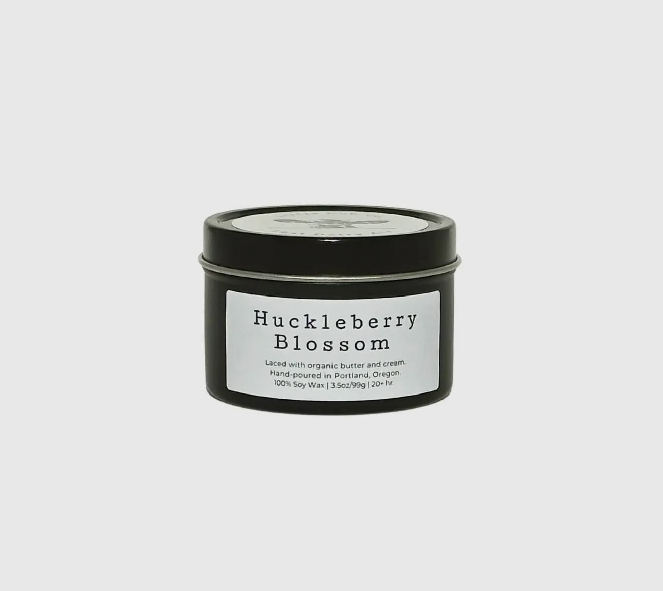 Huckleberry Blossom - Travel Tin - It's a special time of year when Oregon and Washington explode in wild berries, making the late summer air pregnant with sweetness. Huckleberry Blossom brings that delicious wonder into your home any time of year, with ripe huckleberry, sweet nectar and complex notes of honey. Even more decadent? Our candles are laced with butter, so try not to salivate over the smell of fresh-baked huckleberry pie. And please, even though Huckleberry Blossom is made with organic butter and natural soy wax, don't eat the candle – But we won't blame you for wanting to.  100% natural soy wax. Laced with organic butter. Reusable jar with sealing lid.  20+ hr. burn time