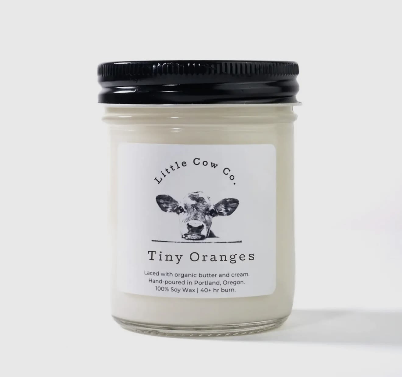 Tiny Oranges - Jar Candle - Few things brighten a home more than the scent of freshly cut fruit. This candle's sweet, cleansing fragrance of orange, grapefruit and peach feels like an open window on a spring day, and will infuse your home with zestful energy.  100% natural soy wax. Laced with organic butter. Reusable jar with sealing lid.  50+ hr. burn time
