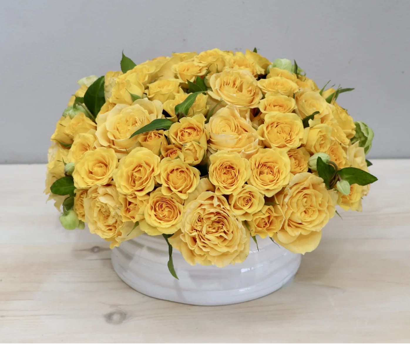 Bright Yellow Roses - WeHo - Over two dozen joyful yellow Roses in a round vase. These bright and sunny flowers are guaranteed to brighten any room.
