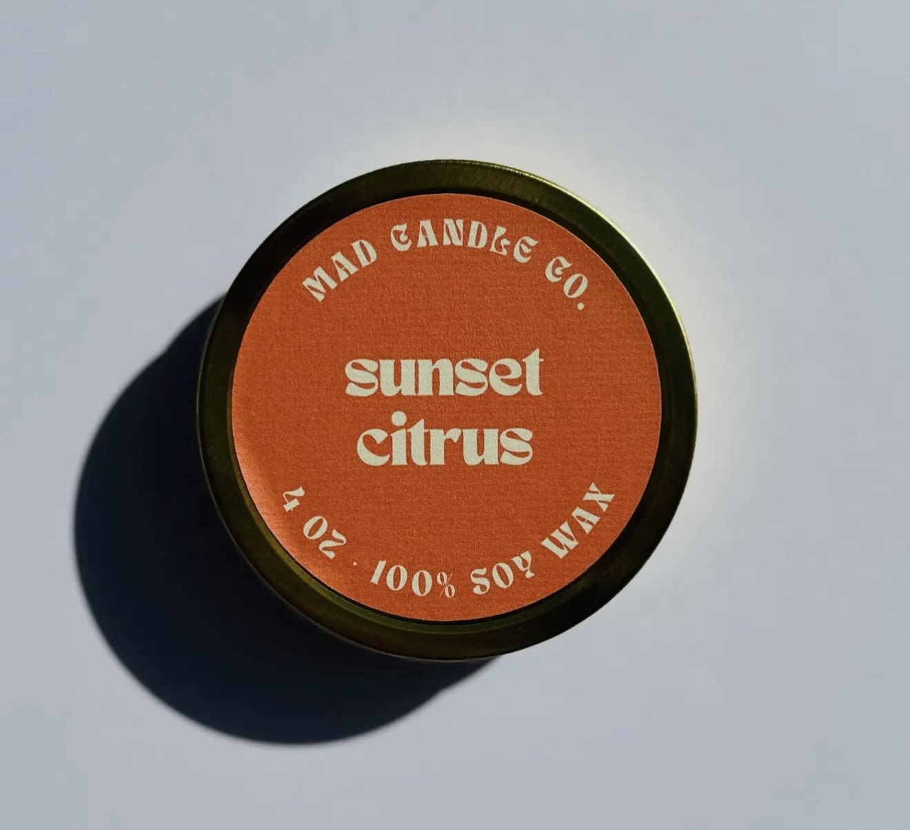 Sunset Citrus Soy Candle - 4 oz Gold Tin &amp; Wood Wick - Lemon Blossom • Olive Leaf • Creamy Orange • Zesty Lemon Peel  A sweet citrus symphony as the sun dips below the horizon. The richness of olive leaf blends beautifully with the zest of lemon peel and the sweet orange blossom, creating a dynamic, refreshing fragrance. This scent captures the golden glow of a sunset, with just a hint of citrusy warmth in the air.