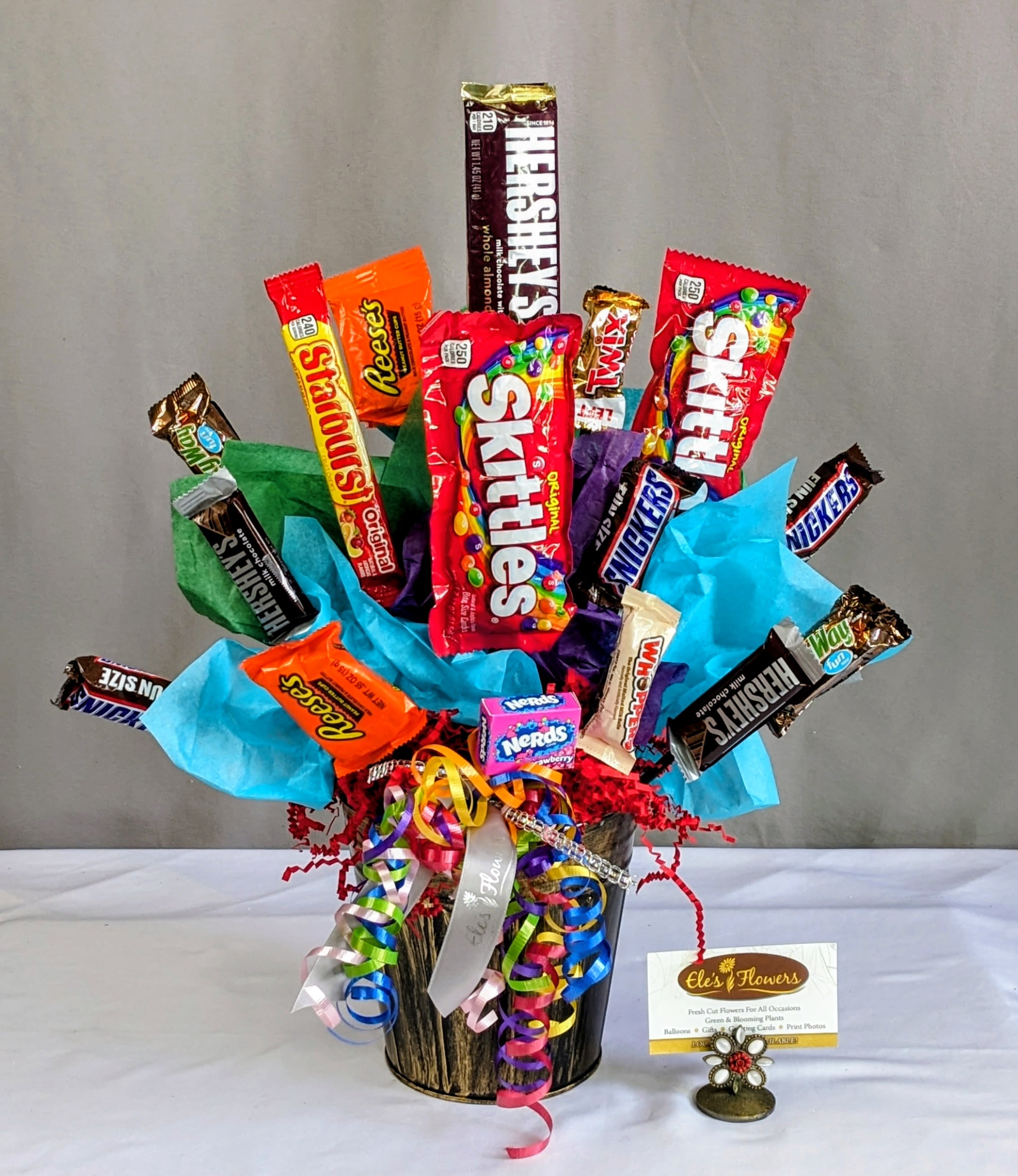 Candy bouquet in a black container with colorful ribbons