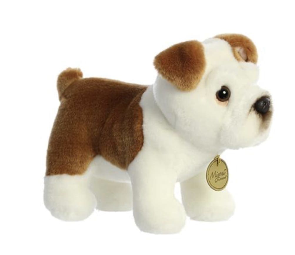 Small brown and white plush bulldog toy with a round gold tag at its neck