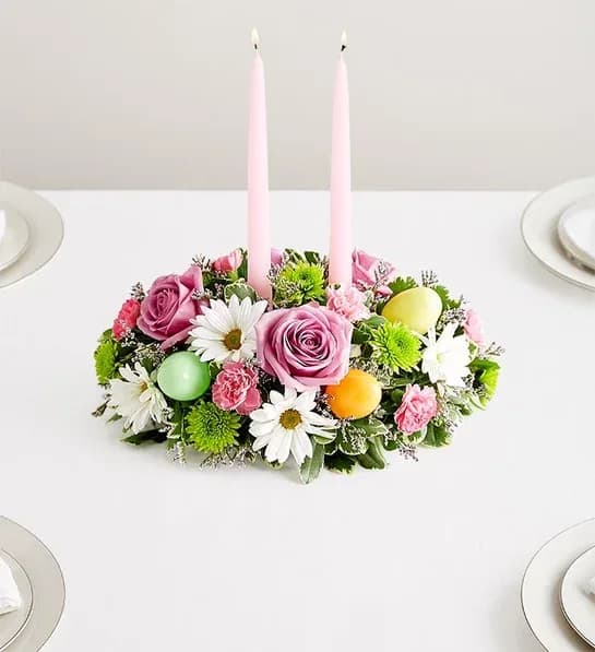 Easter Centerpiece - Easter celebrations call for beautiful flowers. Our classic centerpiece is filled with pastel blooms and accented by colorful plastic Easter eggs for a playful touch. Elegant taper candles finish off this charming arrangement, which is sure to be the bright spot of the holiday table.