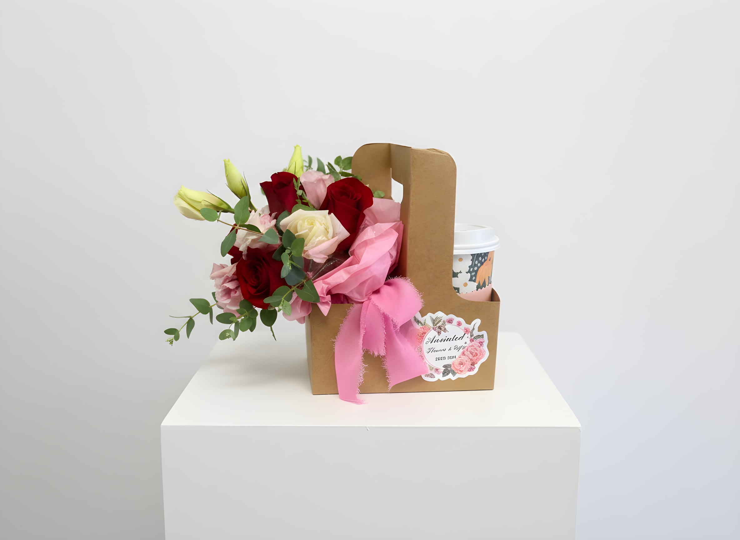 Bloom and Unwind Caddy - A cheerful floral gift created for Galentine’s Day, friendship, and self-care moments. This arrangement features fresh red and pink spray roses styled in a modern kraft carrier with a cozy pick-me-up.  Designed for friends, coworkers, and treating yourself — not a romantic Valentine’s bouquet.   Flowers and accents may vary  Limited quantities available 