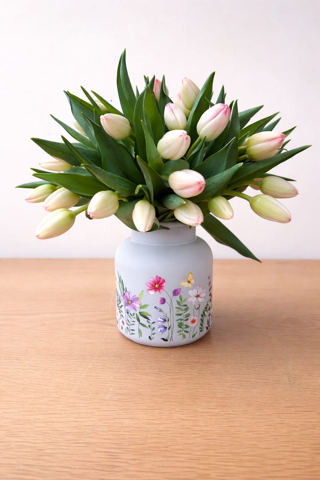 Blush tulips  - A delicate arrangement of blush-tipped ivory tulips, designed in a charming glass vessel. Soft, fresh, and effortlessly elegant—this piece brings a refined spring feel to any space. 