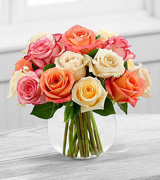 Sundance Rose Bouquet - E9-4817S  The Sundance™ Rose Bouquet employs a soft assortment of roses to create a sweet and stunning arrangement. Cream, white, orange and pink roses are simply brought together in a clear glass bubble bowl vase to make an exquisite flower bouquet set to warm their heart when extending your warmest wishes for their birthday or just to say thinking of you.