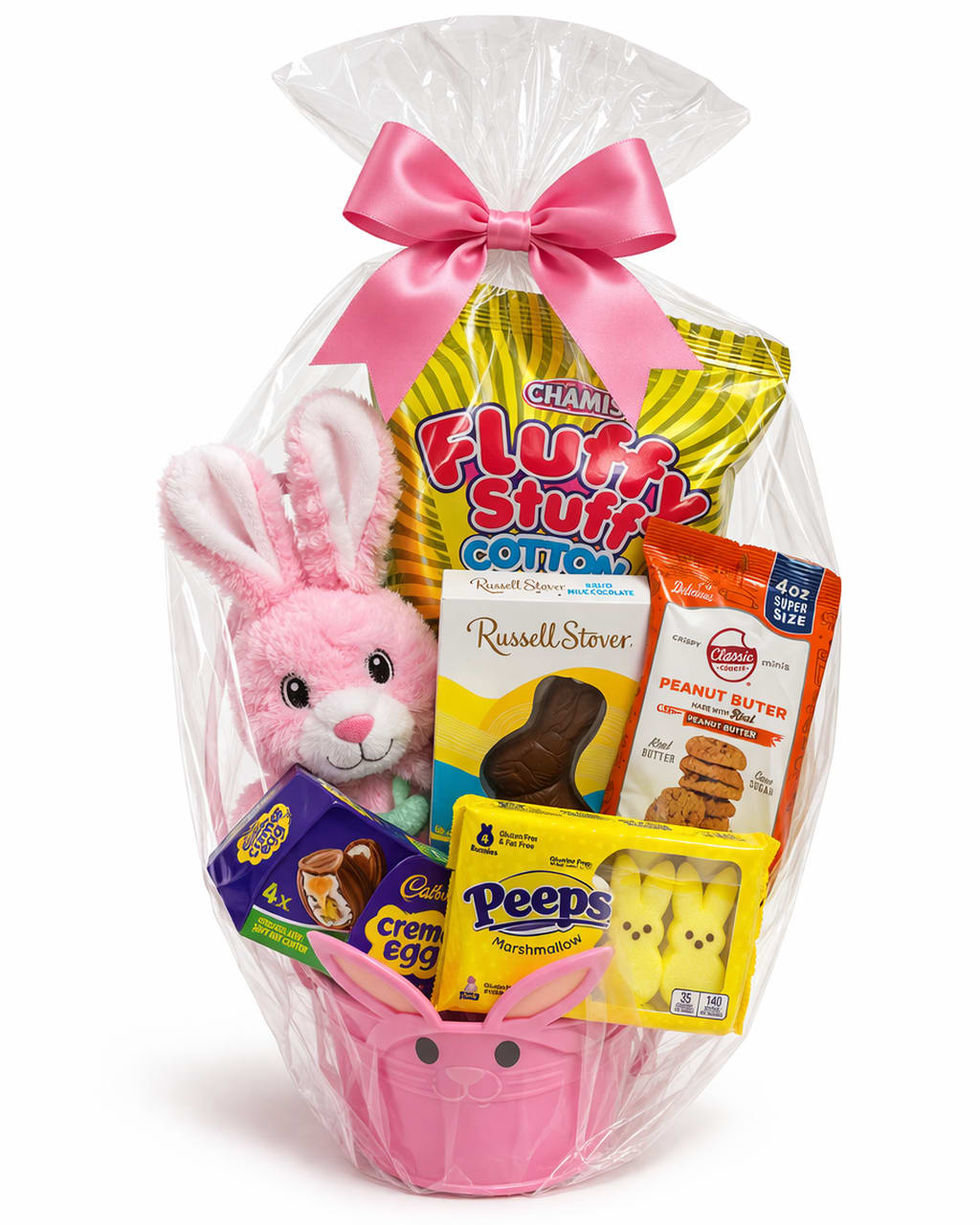 Easter gift basket with pink bunny plush, assorted candies, and cookies in a pink bunny pail wrapped in cellophane