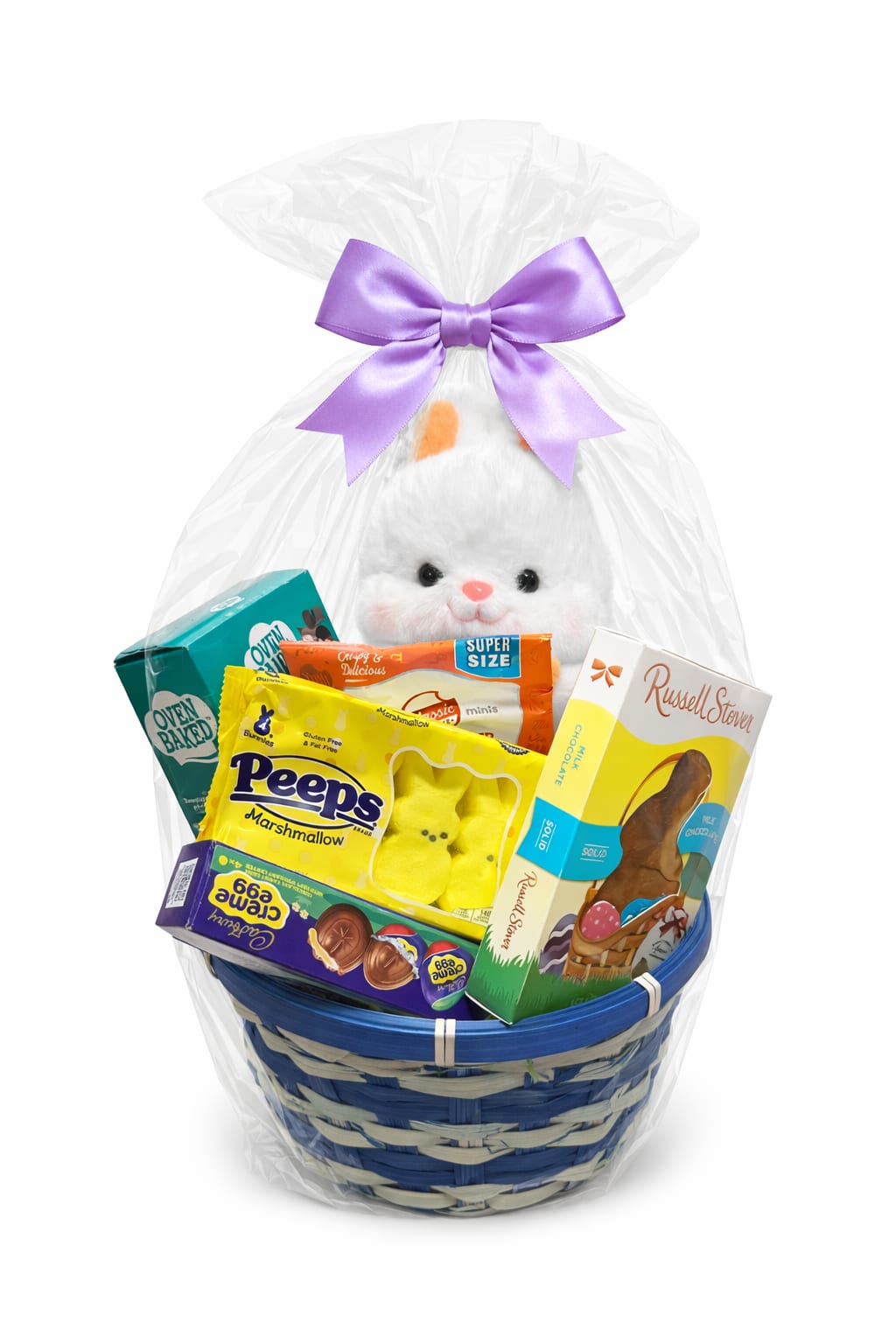 Hoppy Easter Basket - Celebrate Easter with our Hoppy Easter Treat Basket — a fun-filled bundle of classic sweets and cuddly charm. This cheerful basket features a soft plush bunny surrounded by favorite treats like marshmallow Peeps, Cadbury Creme Eggs, Russell Stover chocolate bunny, peanut butter cookies, and fluffy cotton candy.  Wrapped in clear cello and finished with a soft lavender bow, it’s a festive and thoughtful gift perfect for kids of all ages.
