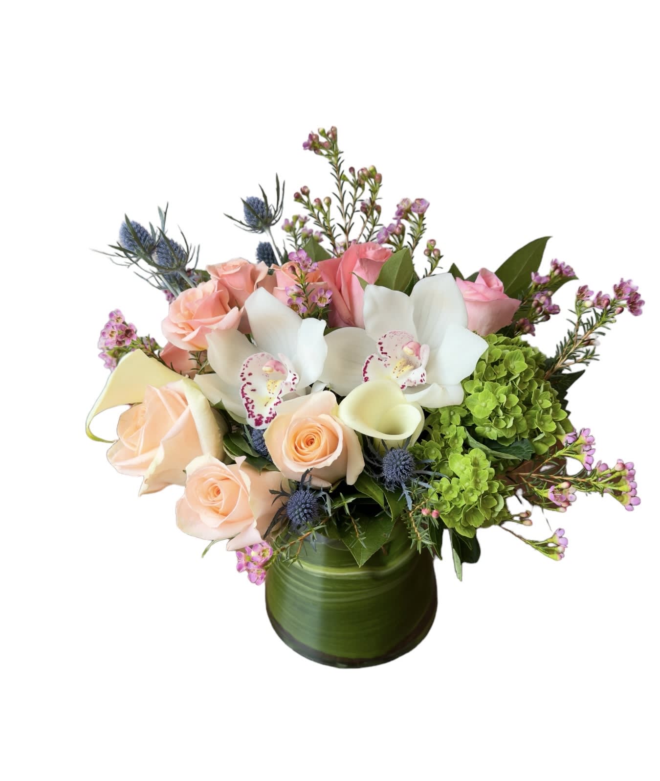 Bouquet of pink roses, white orchids, and green hydrangeas in a green vase