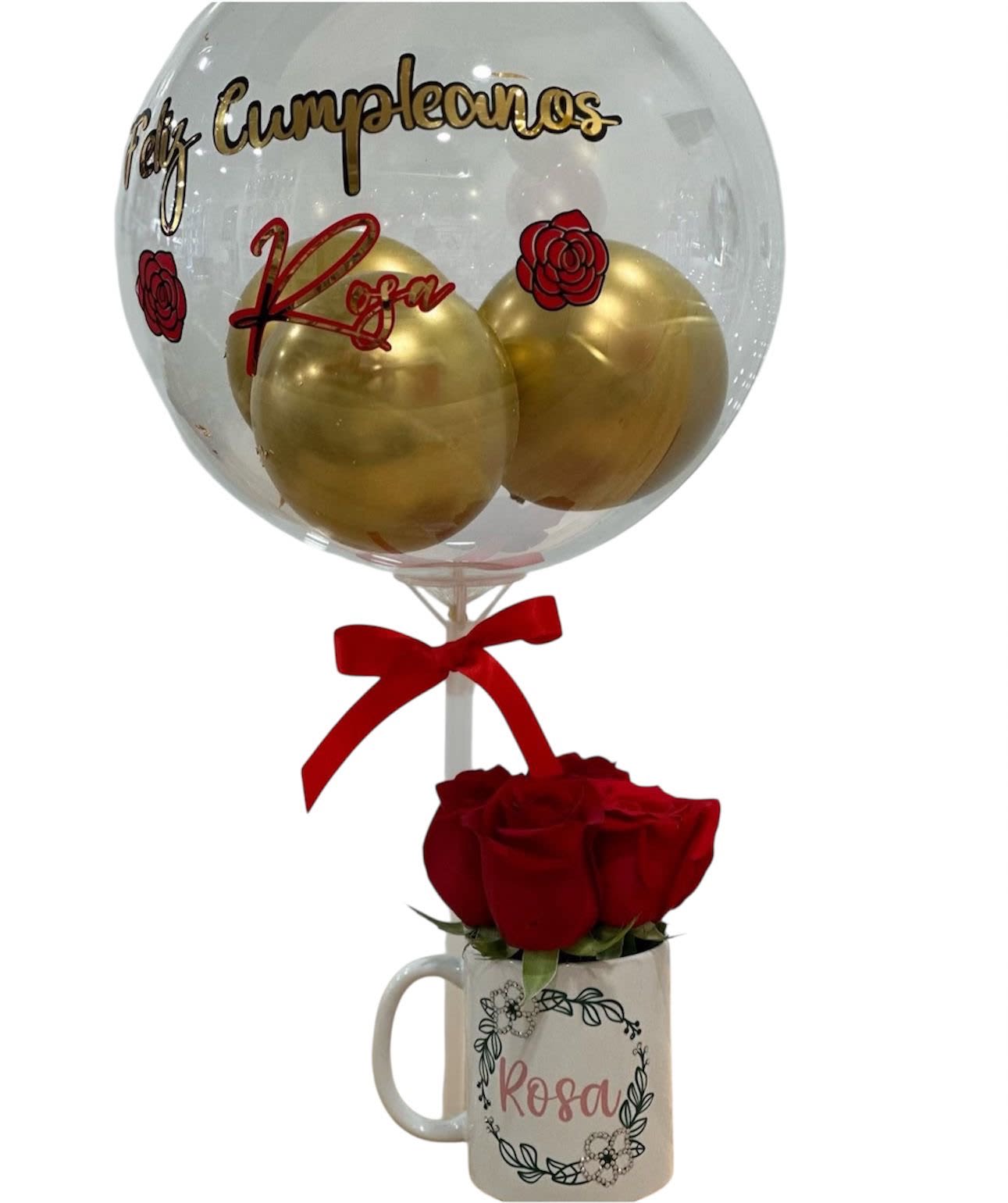 Birthday gift set with clear balloon and golden balloons above a mug of red roses