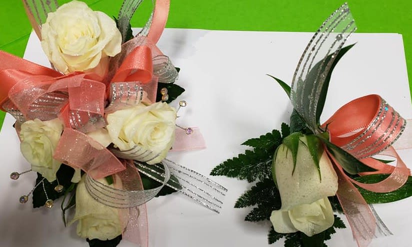 White rose corsage and matching boutonniere with pink and silver ribbon accents