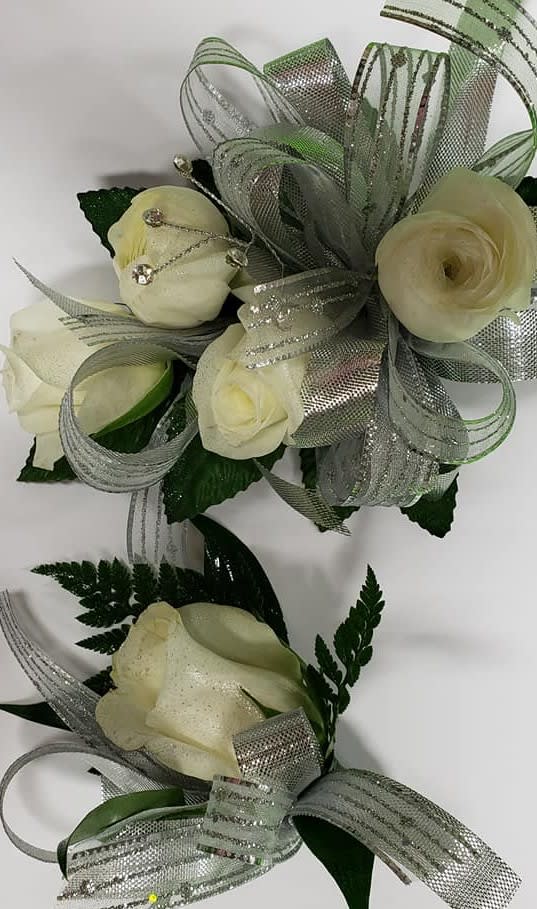 White rose corsage and boutonniere with silver glitter ribbon and crystal accents