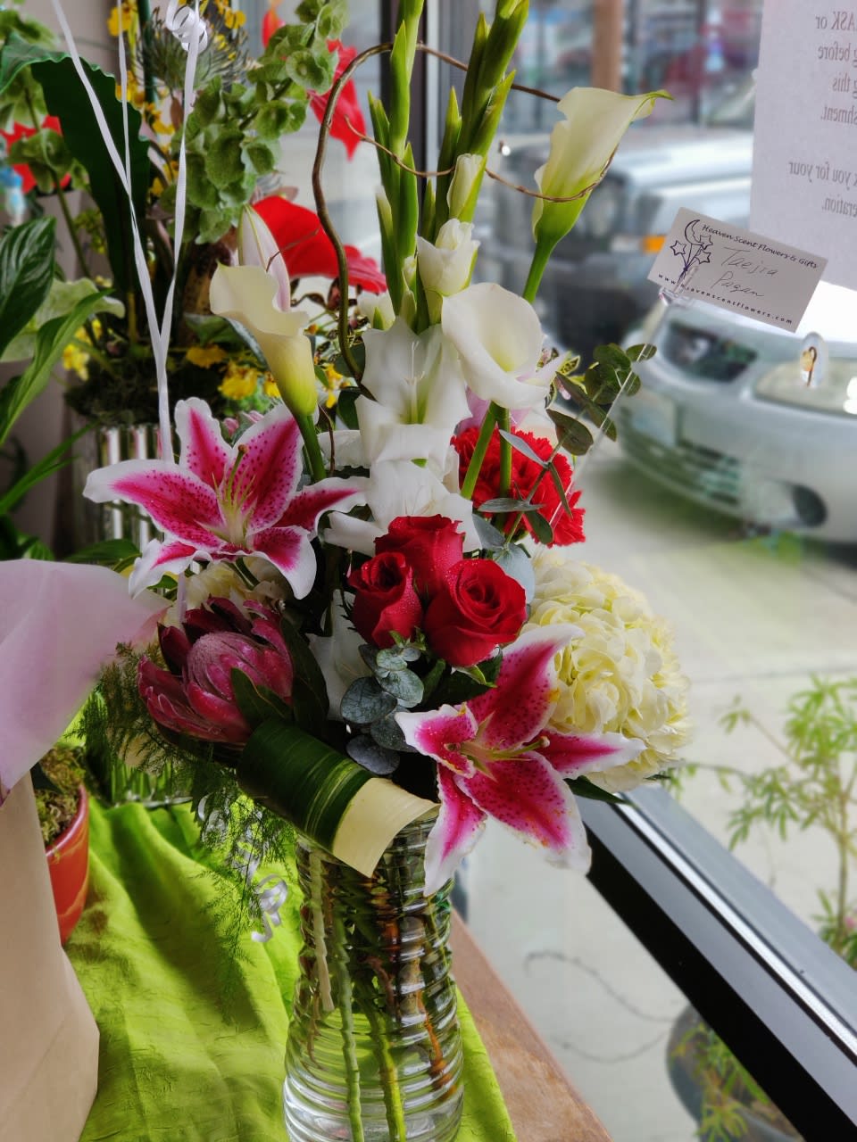 Loveliest of Things - One of our exotic, Ikebana style bouquets, designed beautifully using gladiolus, calla lilies, hydrangeas, stargazer lilies, red roses, carnations, and tropical greenery.