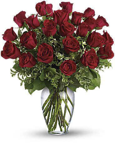 Arrangement of long-stem red roses in a clear glass vase