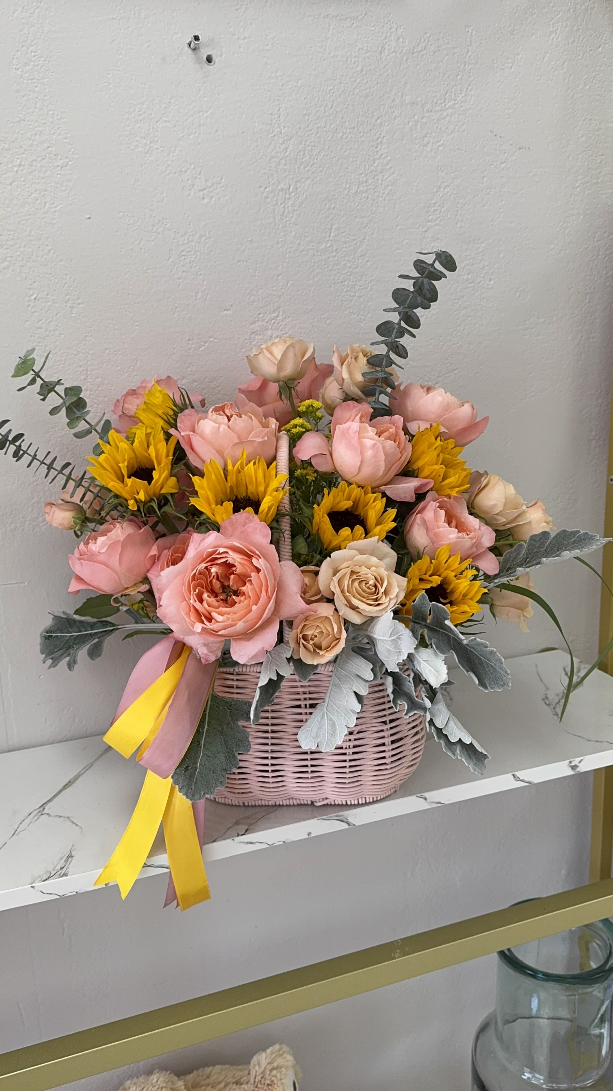 Pink and yellow flower basket with roses and sunflowers